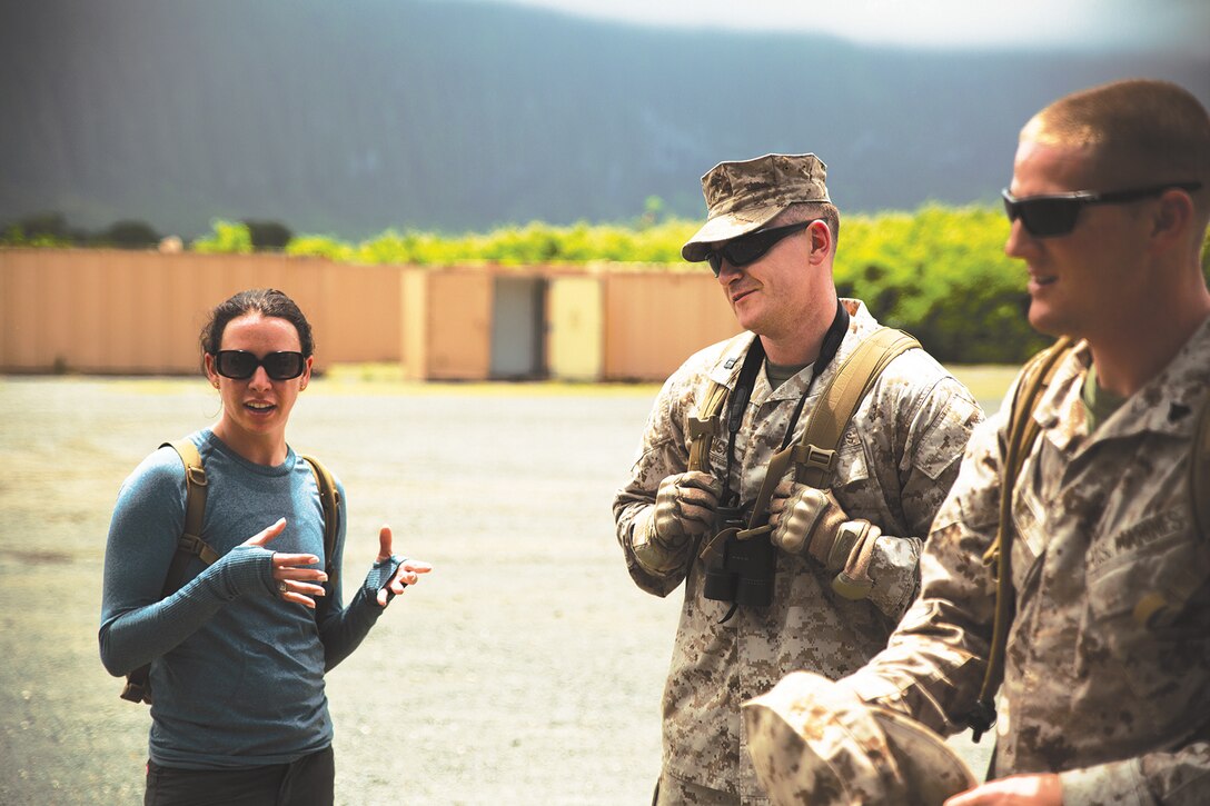 Emily Cook, a three time U.S. Olympian and six time U.S. champion in aerial skiing, shares her thoughts on the combat hunter training she received with School of Infantry West Detachment Hawaii Marines at Marine Corps Training Area Bellows, April 17, 2014. Cook traveled to Hawaii with American300, an educational organization which sponsors activities aimed at motivating and honoring U.S. service members, and trained alongside Marines for several days. At MCTAB, Cook learned how Marines use tracking techniques to lead them to their target. (U.S. Marine Corps photo by Lance Cpl. Matthew Bragg)