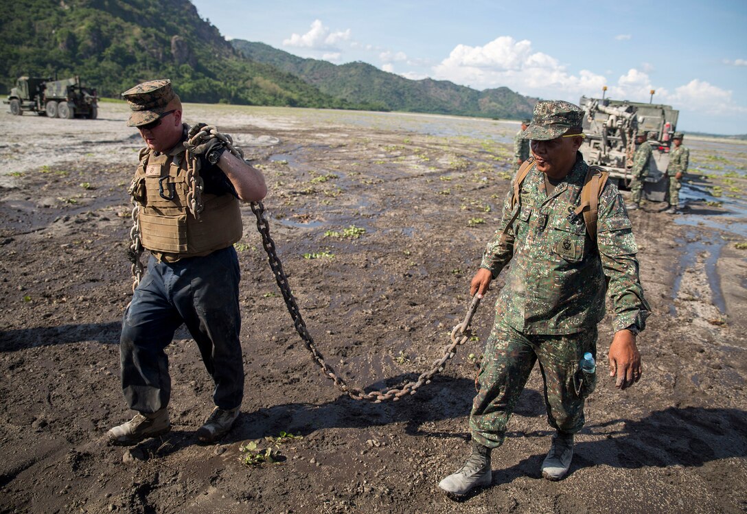Philippine and U.S. Marines stand shoulder-to-shoulder during a vehicle recovery training event, May 12, 2014 in Crow Valley, Philippines during Balikatan 2014. The training was part of the culminating event between the logistics combat element of U.S. Marine Forces Balikatan and the Philippine Marines. Balikatan is an annual training exercise that strengthens the interoperability between the Armed Forces of the Philippines and U.S. military and their commitment to regional security and stability, humanitarian assistance and disaster relief. The Philippine Marines are with Motor Transport and Maintenance Battalion, Combat Service Support Brigade, Philippine Marine Corps. The U.S. Marines are with 3rd Maintenance Battalion, 3rd Marine Logistics Group, III Marine Expeditionary Force. (U.S. Marine Corps photo by Lance Cpl. Joey S. Holeman/Released)
