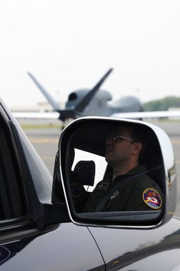 U.S. Air Force Col. Stephen Williams, 35th Fighter Wing commander, watches the RQ-4 Global Hawk conduct its first historic landing in Japanese territory on Misawa Air Base, May 24, 2014. During Operation Tomodachi, the Global Hawk was able to identify passable roads and territory to enable first responders to plan ingress and egress routes. The long-range and infrared cameras on the remotely piloted aircraft, provided commanders with more than 3,000 images of the disaster zone. (U.S. Air Force photo/Tech. Sgt. April Quintanilla)