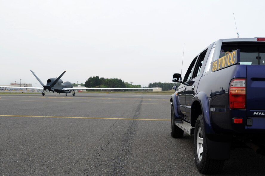 Misawa Air Base leadership follows behind the RQ-4 Global Hawk as it taxis for the first time in Japanese territory, May 24, 2014. This historic event was decided, in part, as a result of the adverse impact of inclement summer weather on U.S. intelligence, surveillance, and reconnaissance operations in Guam. The Global Hawk is scheduled to be temporarily assigned to Misawa AB from Andersen AFB, Guam, through October. (U.S. Air Force photo/Tech. Sgt. April Quintanilla)