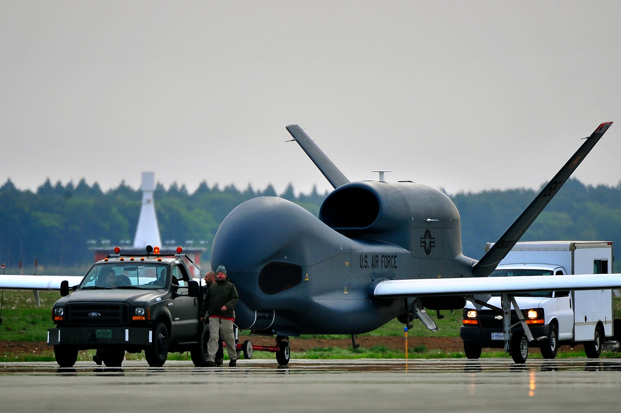 An RQ-4 Global Hawk from Andersen Air Force Base, Guam is towed down the taxiway at Misawa Air Base, Japan, May 24, 2014. The RQ-4 Global Hawk is a high-altitude, long-endurance unmanned aircraft system with an integrated sensor suite that provides intelligence, surveillance and reconnaissance, or ISR, capability worldwide. (U.S. Air Force photo/Staff Sgt. Nathan Lipscomb)