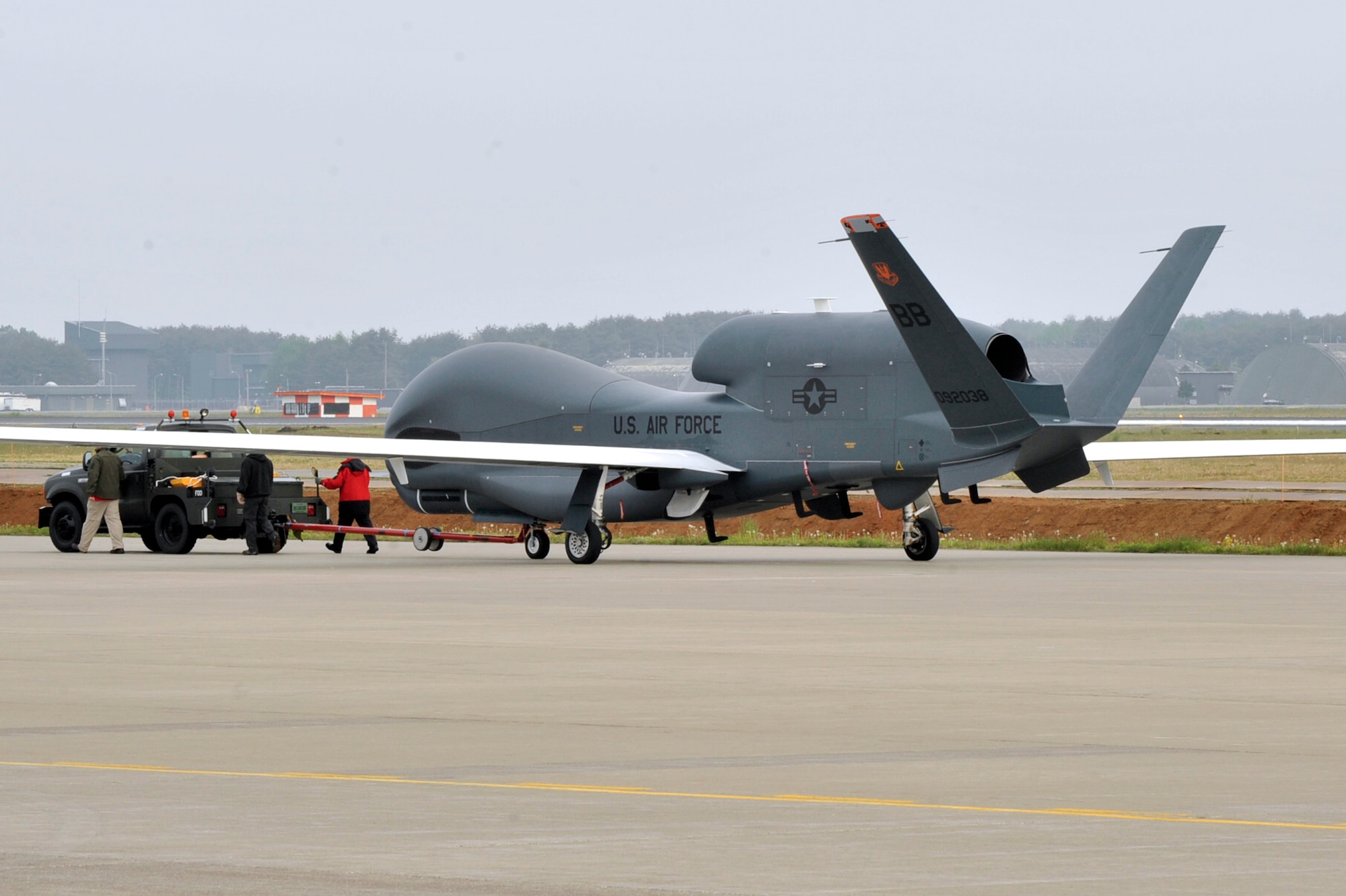A RQ-4 Global Hawk from Andersen Air Force Base, Guam is towed down the taxiway at Misawa Air Base, Japan, May 24, 2014. The Global Hawk is on a temporary rotation to Japan, in part, as a result of the adverse impact of inclement summer weather on intelligence, surveillance, and reconnaissance missions operations in Guam. Given the number of sorties lost due to typhoons and thunderstorms, the need to look for alternate summer basing options arose. Misawa AB was chosen as an ideal location for the Global Hawk, its equipment and personnel. (U.S. Air Force Photo/ Staff Sgt. Tong Duong)