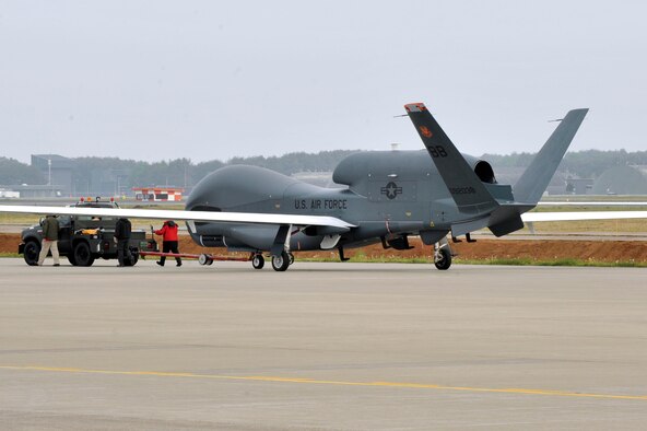 A RQ-4 Global Hawk from Andersen Air Force Base, Guam is towed down the taxiway at Misawa Air Base, Japan, May 24, 2014. The Global Hawk is on a temporary rotation to Japan, in part, as a result of the adverse impact of inclement summer weather on intelligence, surveillance, and reconnaissance missions operations in Guam. Given the number of sorties lost due to typhoons and thunderstorms, the need to look for alternate summer basing options arose. Misawa AB was chosen as an ideal location for the Global Hawk, its equipment and personnel. (U.S. Air Force Photo/ Staff Sgt. Tong Duong)
