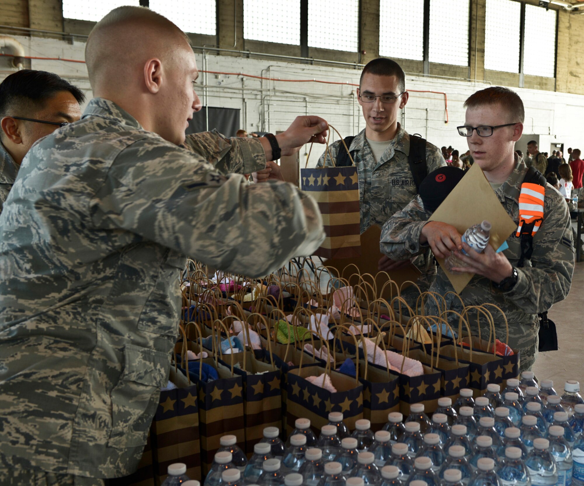 Single 726th Air Control Squadron Airmen receive welcome-home packages after returning from deployment to various locations in Afghanistan and Southwest Asia, and were reunited with family and friends at a celebration at the Mountain Home Air Force Base flightline, May 23, 2014, at the base in Southwestern Idaho. 'Hardrock' Airmen provided time critical battle management command and control using sensors and communication located across Afghanistan. (U.S. Air Force photo by Master Sgt. Kevin Wallace/RELEASED)