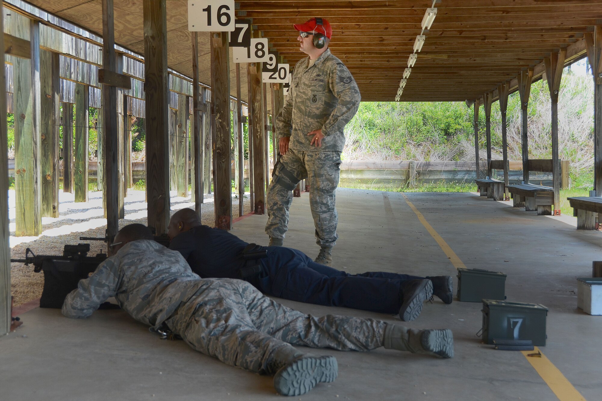 Senior Airman Marcus Heyward, retired U.S. Army MSgt Edward Earle and Staff Sgt. Kenvyn Lewis, assigned to the 169th Security Forces Squadron, instructs fellow South Carolina Air National Guard members during M4 Carbine training at McEntire Joint National Guard Base, S.C May 21, 2014. Weapons qualification is an essential component of Airmen readiness and safety at home and abroad.  (U.S. Air National Guard photo by Airman 1st Class Ashleigh S. Pavelek/Released)