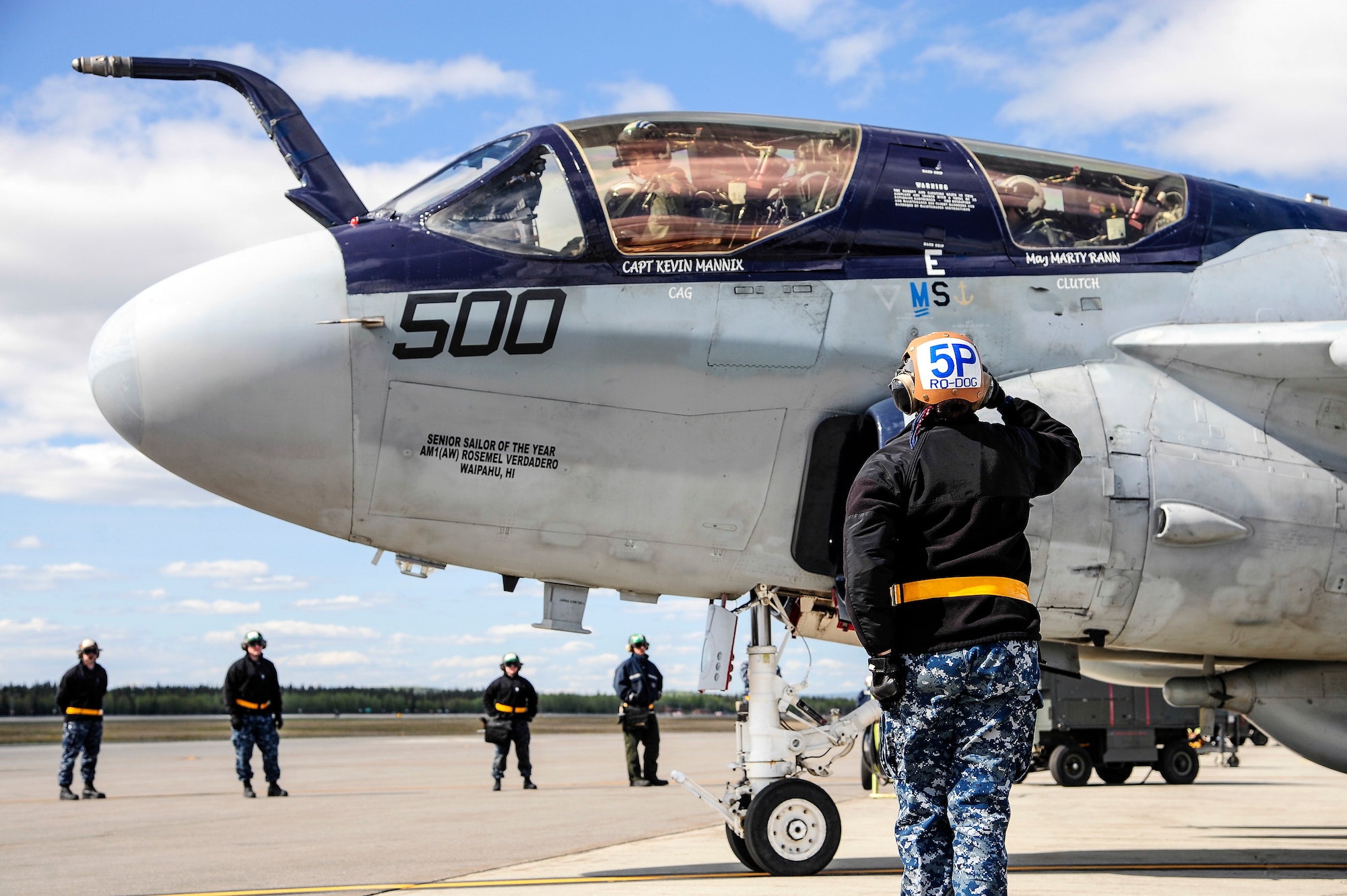 A U.S. Navy EA-6B Prowler crew chief from the Electronic Attack Squadron 142, Naval Air Station Whidbey Island, Oak Harbor, Wash., salutes Navy Lt. Candice Nunley, VAQ-142 Prowler pilot, during RED FLAG-Alaska 14-1 May 22, 2014, Eielson Air Force Base, Alaska. The Prowler carries out missions by jamming enemy radar systems and gathering radio intelligence on enemy air defense systems. (U.S. Air Force photo by Senior Airman Zachary Perras/Released)