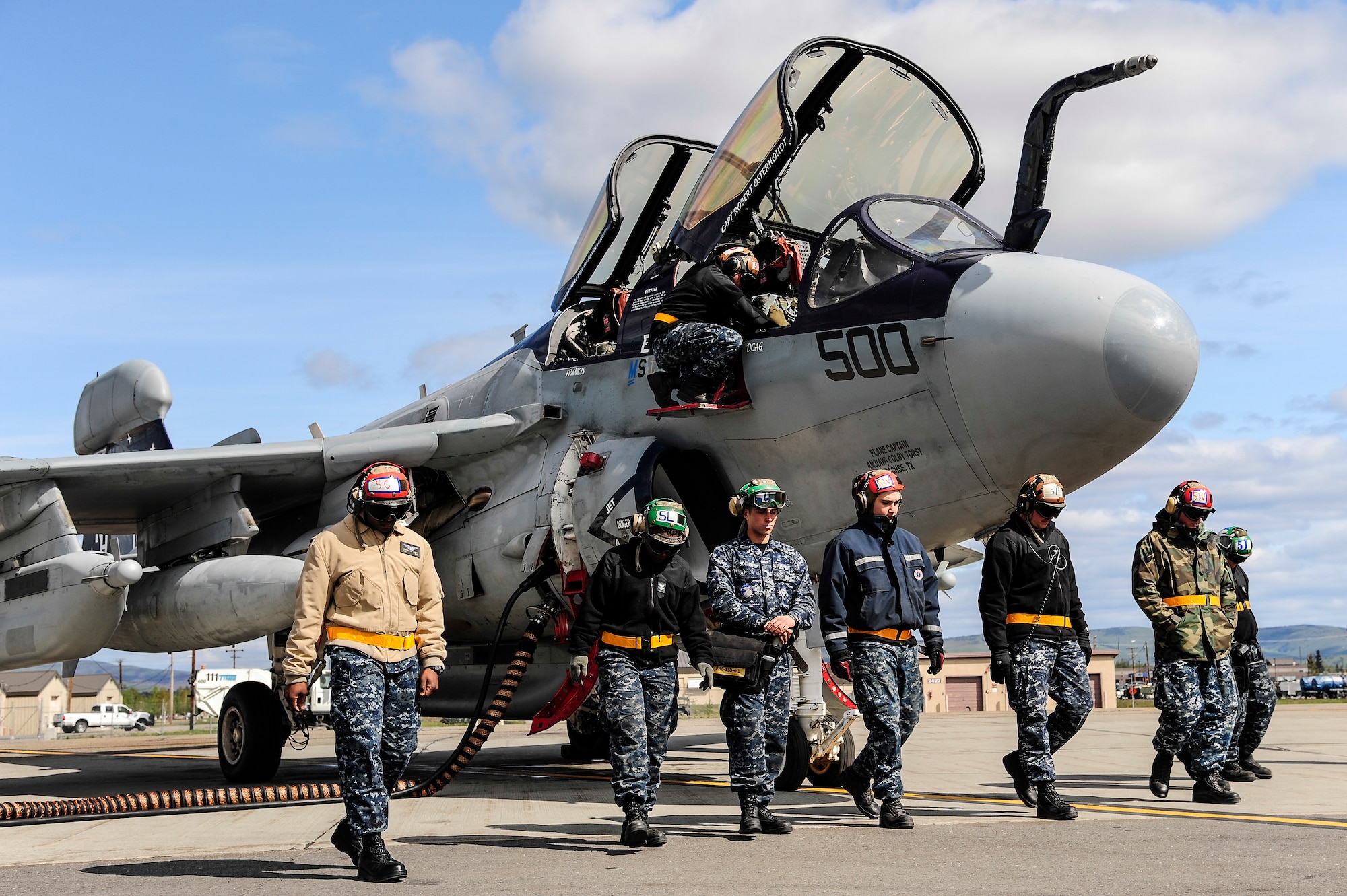 U.S. Navy EA-6B Prowler crew chiefs from the Electronic Attack Squadron 142, Naval Air Station Whidbey Island, Oak Harbor, Wash., perform a foreign object debris walk May 21, 2014, Eielson Air Force Base, Alaska. VAQ-142 is participating in RED FLAG-Alaska 14-1, the first of four RF-A exercises for 2014. (U.S. Air Force photo by Senior Airman Zachary Perras/Released)