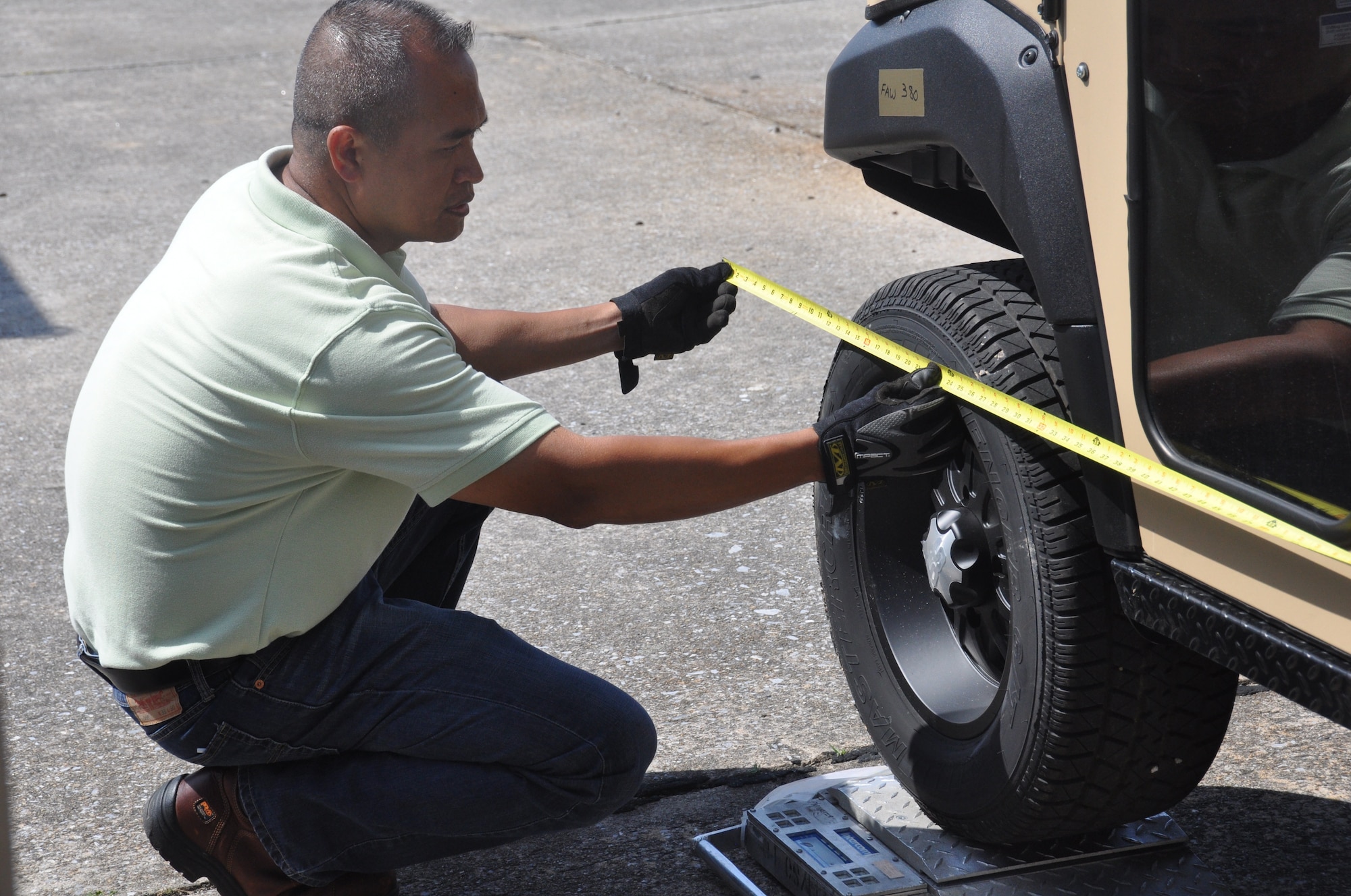 Reynante Rivera, of the 94th Logistics Readiness Squadron Transportation and Management Office, checks measurements during a cargo inspection, May 21, 2014, Dobbins Air Reserve Base, Ga. During these inspections, the TMO ensures that the cargo is airworthy, clean, contraband free, and that all of the figures match. If not done properly, the safety of the aircraft may be compromised. (U.S. Air Force photo/Senior Airman Miles Wilson)  