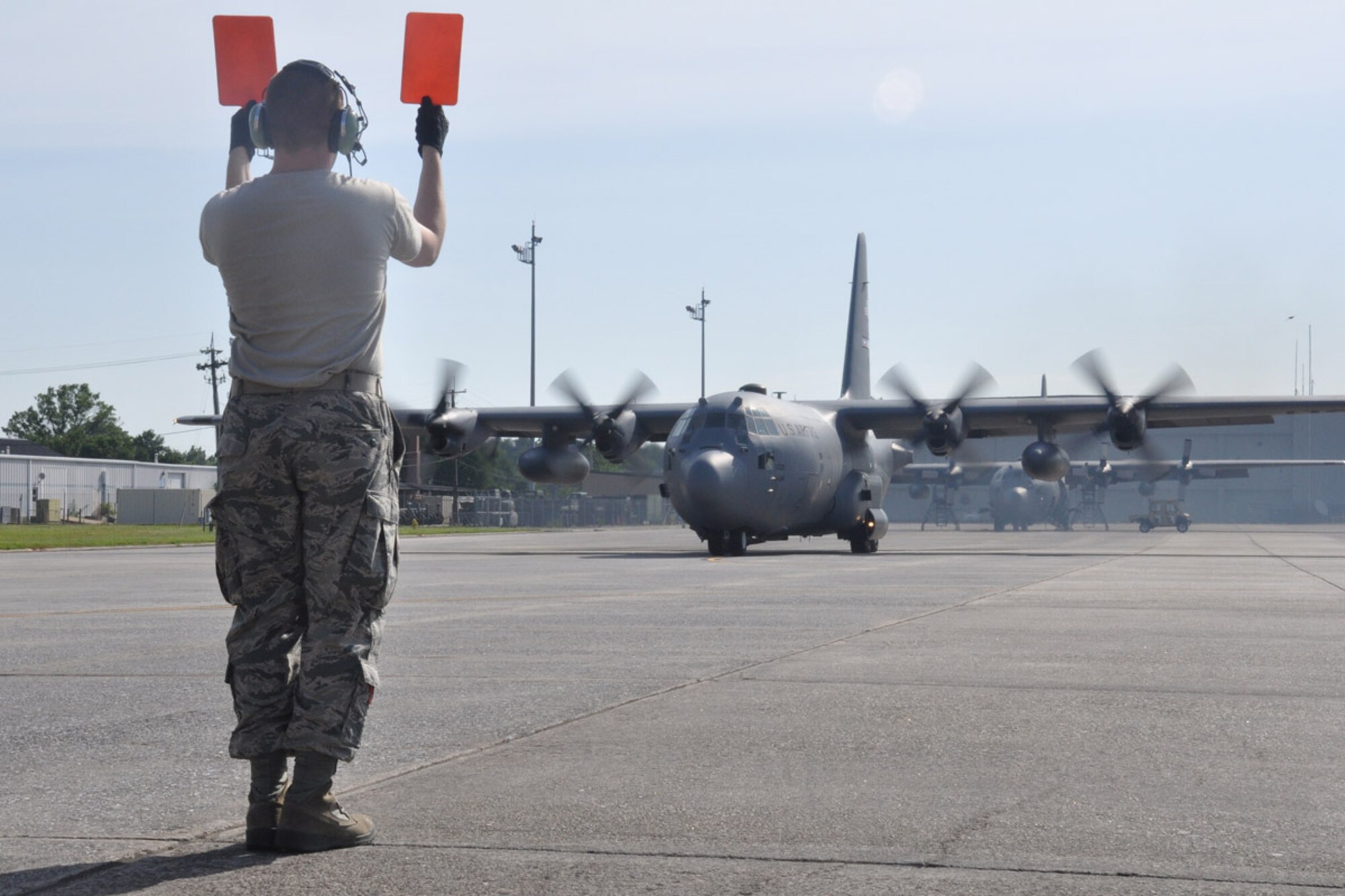 A C-130 aircraft is marshalled onto the runway by Airman 1st class Joshua Laber, 94th Aircraft Maintenance Squadron crew chief, May 21, 2014, Dobbins Air Reserve Base, Ga. The take-off of the aircraft signified the beginning of the 2014 Maple Flag exercise, a mission that simulates an air combat environment and involves large formation maneuvers against airborne and ground-based threats. (U.S. Air Force photo/Senior Airman Miles Wilson)