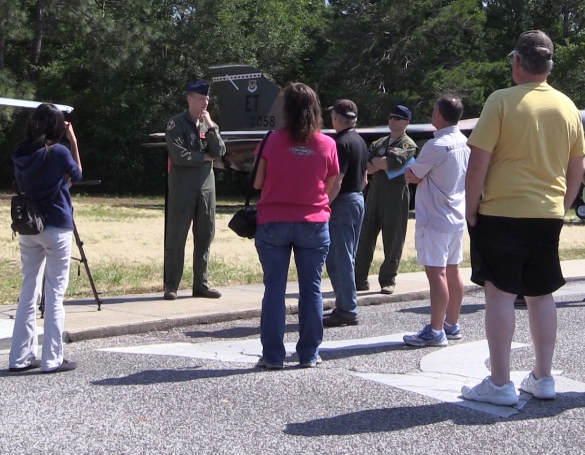 Maj. Tucker Hamilton, a pilot with the 40th Flight Test Squadron, tapes an interview for a CPALMS video at the Air Force Armament Museum while visitors watch.  The videos will link to Florida state standards for use by teachers. (courtesy photo)