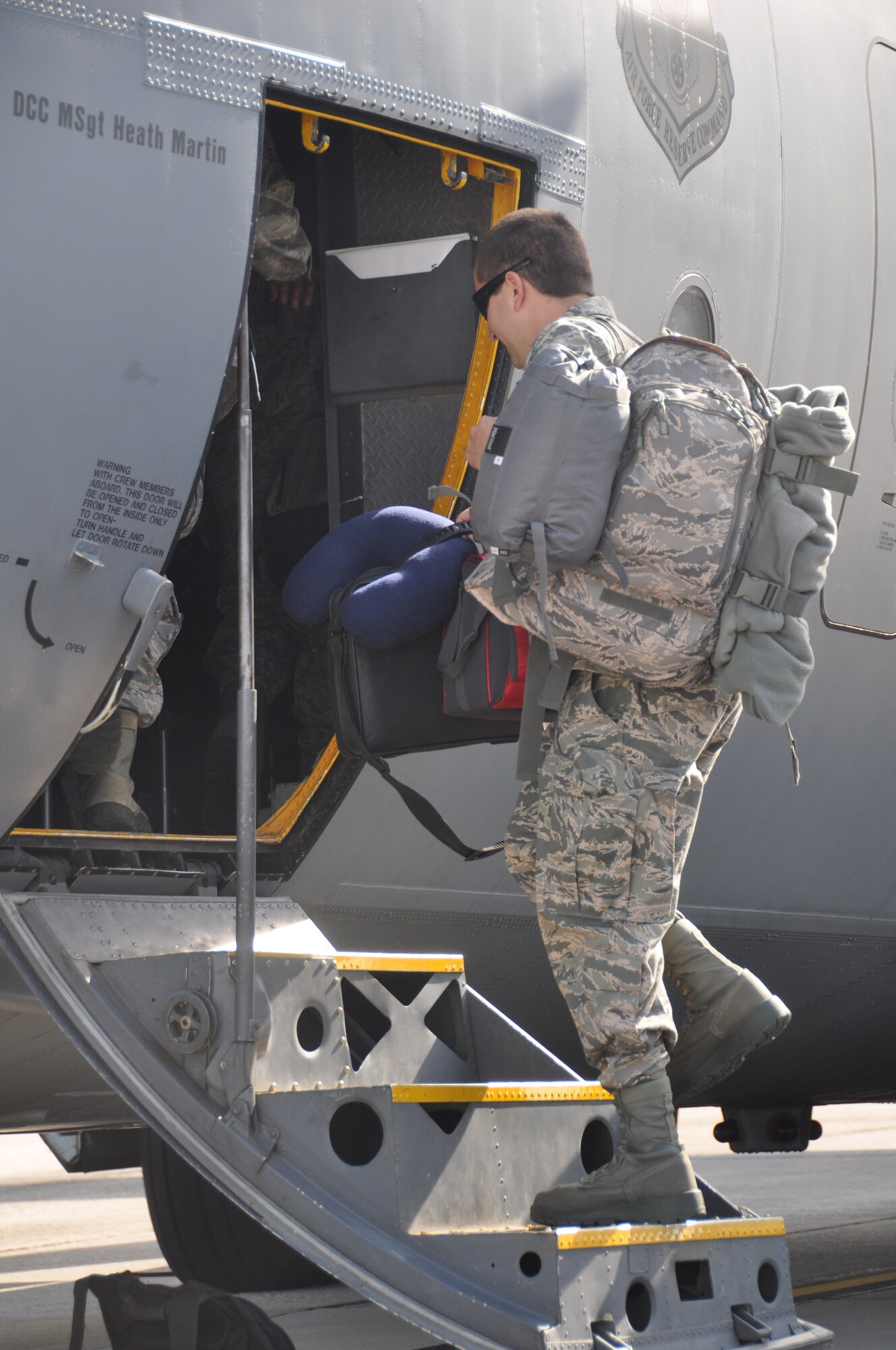 A member of the 94th Maintenance Group enters a C-130 aircraft prior to departure, May 21, 2014, Dobbins Air Reserve Base, Ga. Members from the 94th Airlift Wing departed for Maple Flag 47, an exercise that involves coalition forces from across the globe training together in an effort to maximize unique training opportunities and cooperation between joint forces. (U.S. Air Force photo/Senior Airman Miles Wilson)