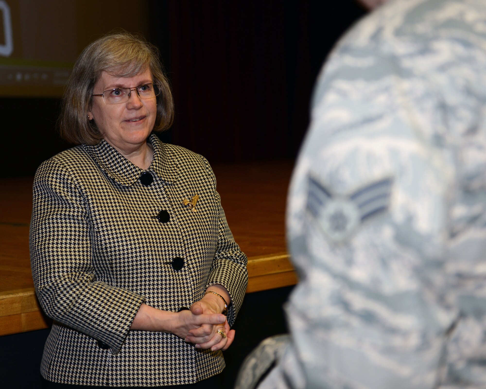Holly Petraeus, assistant director of the Consumer Financial Protection Bureau's Office of Servicemember Affairs and wife of retired U.S. Army Gen. David Petraeus, answers a Team Mildenhall Airman’s questions after an all-call May 23, 2014, on RAF Mildenhall, England. Petraeus briefed Airmen about how to responsibly handle money and not be taken advantage of by certain businesses which may prey on service members. (U.S. Air Force photo by Airman 1st Class Preston Webb/Released)