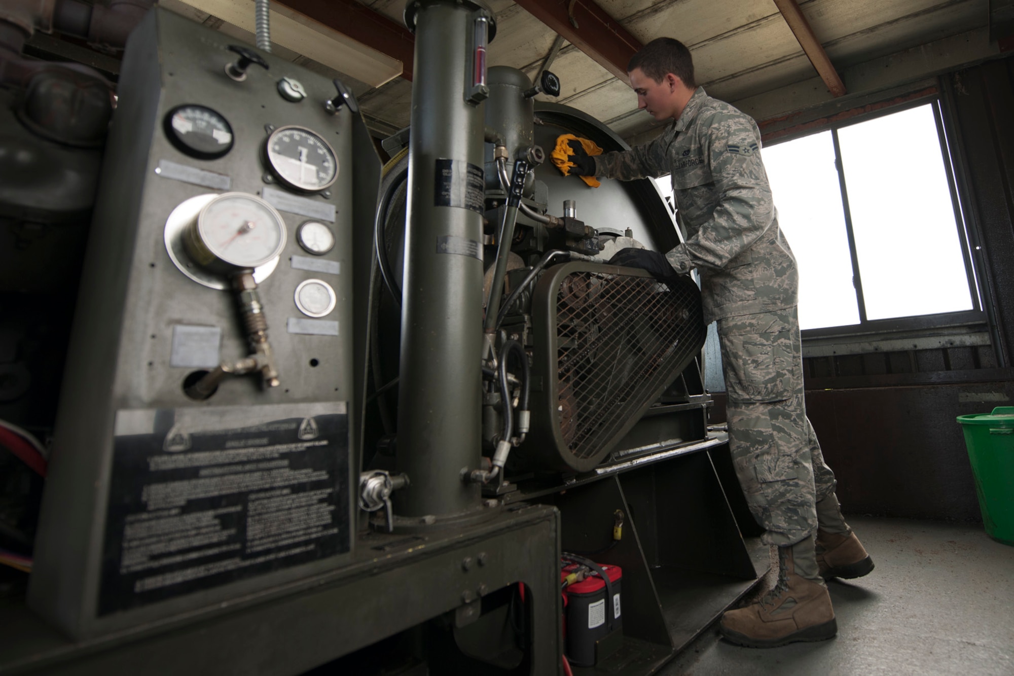 U.S. Air Force Airman 1st Class Andrew Ferraro, 65th Civil Engineer Squadron power production technician, cleans an aircraft arresting system during a preventive maintenance inspection May 20, 2014, at Lajes Field Azores, Portugal. The power production office maintains the AAS to ensure the integrity of the system. In the event of an inflight emergency the AAS will stop an aircraft that is equipped with a tail hook to prevent loss of aircraft and life. (U.S. Air Force by Tech. Sgt. Paul Villanueva II/Released)