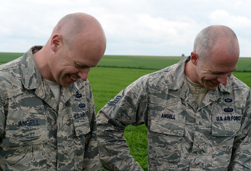 Tech. Sgt. Brian Angell, 435th Contingency Response Group personnel parachute program manager (left) and Master Sgt. Kevin Angell, Special Operations Command Korea, NCO in charge of communications directorate, Tucson, Arizona, natives, laugh about their jumps during International Jump Week at Alzey landing zone, Germany, May 8, 2014. More than 300 jumpers from nine different nations performed a total of 404 static-line jumps and 132 high-altitude low-opening jumps during jump week. (U.S. Air Force photo/Airman 1st Class Michael Stuart) 