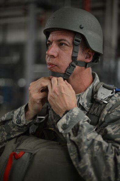 Master Sgt. Kevin Angell, Special Operations Command Korea, NCO in charge of communications directorate, Tucson, Arizona, native, straps on his helmet as he waits to board a C-130 at Ramstein Air Base, Germany, May 8, 2014. Angell flew in from Korea to jump with his younger brother, Tech. Sgt. Brian Angell, 435th Contingency Response Group personnel parachute program manager, for the first time in both of their careers. (U.S. Air Force photo/Airman 1st Class Michael Stuart)