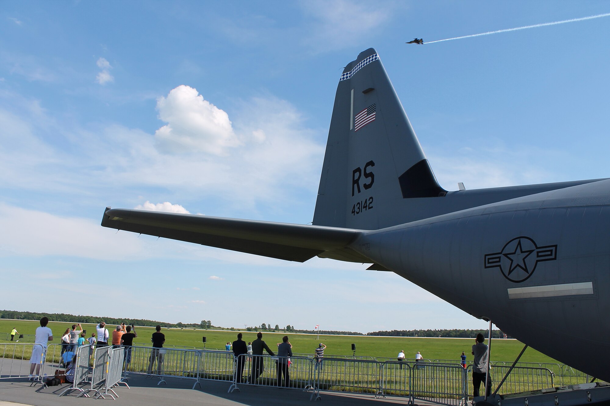 Capt. Jeff Broffman, C-130J Super Hercules pilot, watches as a Turkish F-16 demonstration pilot performs at the 2014 Berlin Trade and Air Show, Berlin, May 21, 2014. The bi-annual trade show was open to the public and provided Airmen the opportunity to showcase the nation’s leading aerospace technologies and equipment used by the U.S. Air Force.