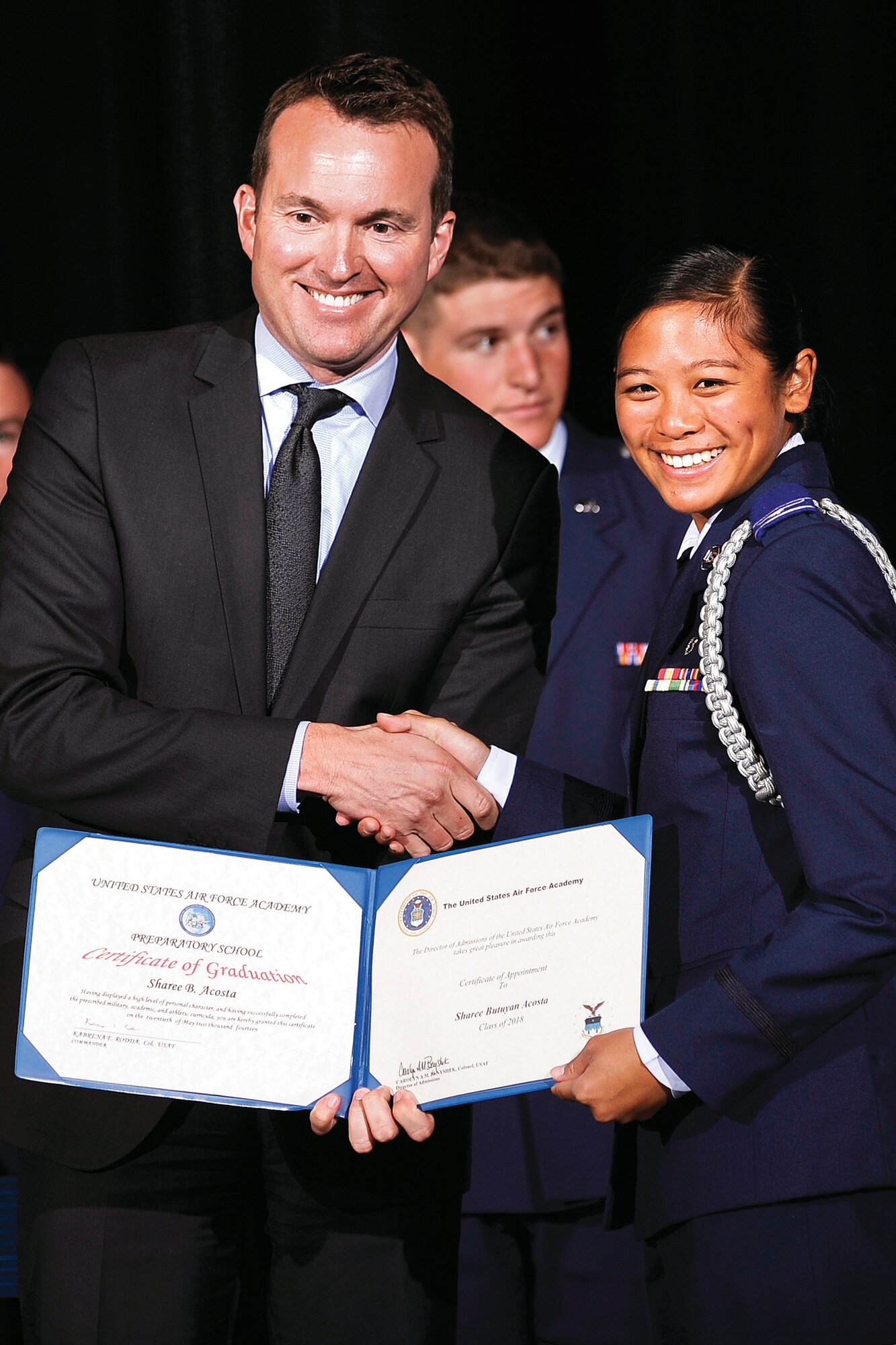 Academy Prep School graduate Sharee Acosta smiles after receiving her Prep school diploma from Under Secretary of the Air Force Eric Fanning during the Prep School’s 2014 graduation ceremony here May 20.