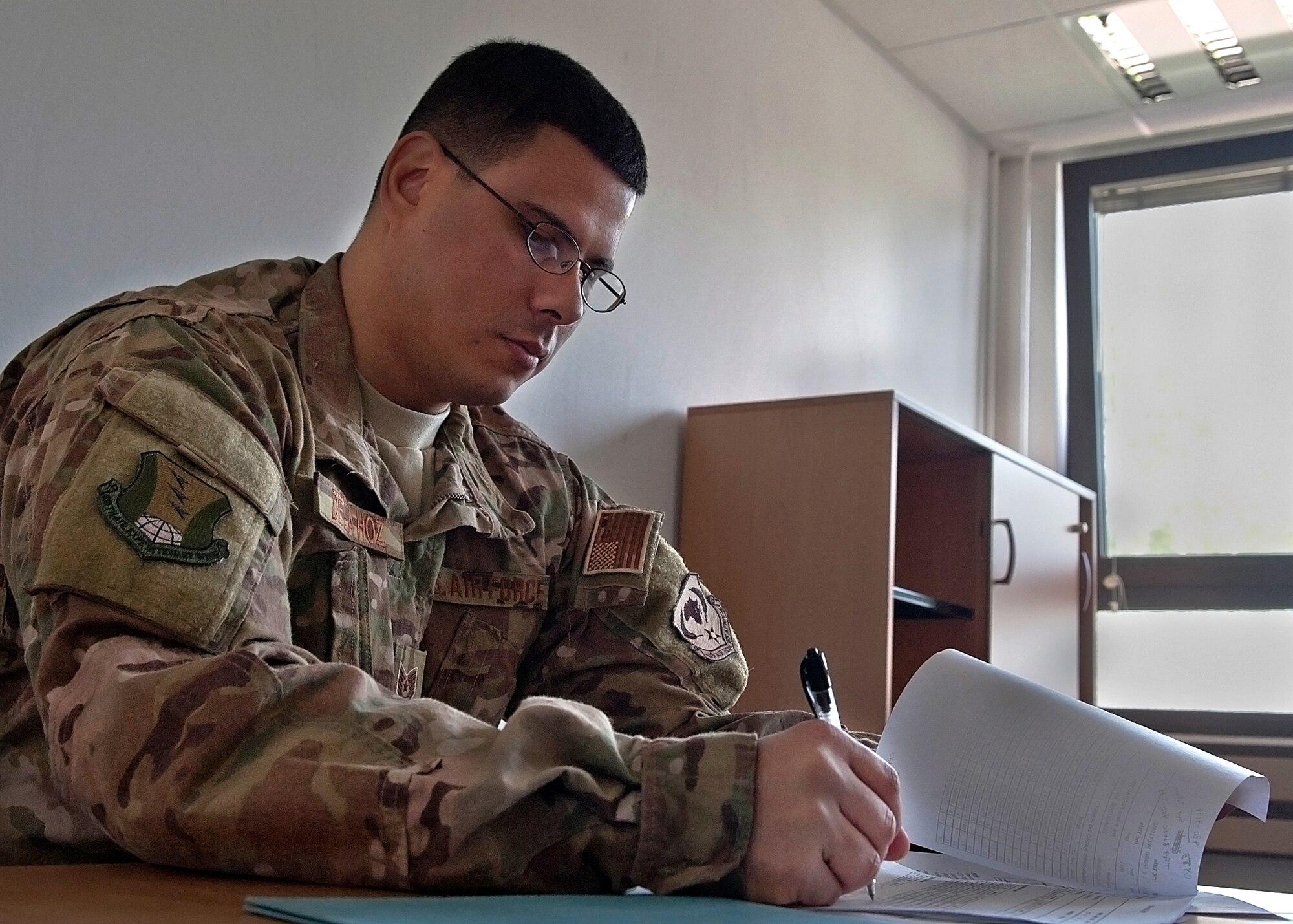 Tech. Sgt. Vincent De La Hoz, 48th Logistics Readiness Squadron deployment NCO in charge, reviews details for an exercise while deployed at Ramstein Air Base, Germany, May 22, 2014. De La Hoz was nominated for a Liberty Spotlight because he displays the core value of Service Before Self. (U.S. Air Force photo by Airman Larissa Greatwood/Released)