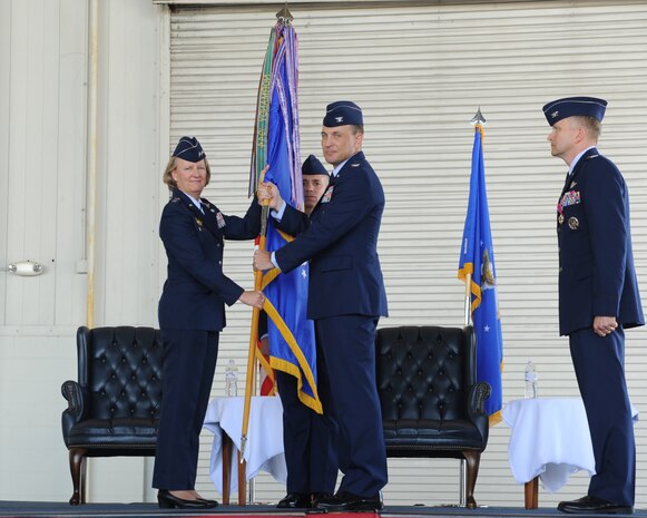 Col. John Lamontagne (right) accepts the 437th Airlift Wing guidon from Maj. Gen. Barbara Faulkenberry, 18th Air Force commander, during the 437th AW change of command ceremony May 22, 2014, in Nose Dock 2 at Joint Base Charleston - Air Base, S.C. Lamontagne took command from Col. Darren Hartford, whose next assignment is 379th Air Expeditionary commander in Al Udeid. (U.S. Air Force photo/Staff Sgt. William O’Brien)