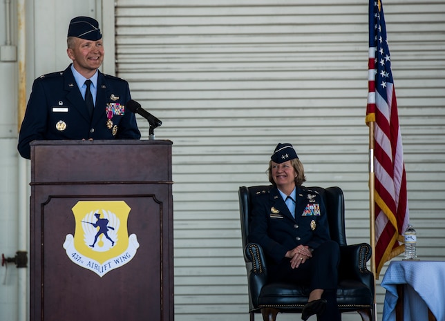 Maj. Gen. Barbara Faulkenberry, 18th Air Force commander, Col. Darren Hartford and Col. John Lamontagne, salute the American flag during the National Anthem before the 437th Airlift Wing change of Command ceremony on May 22, 2014, in Nose Dock 2 at Joint Base Charleston - Air Base, S.C. (U.S. Air Force photo/Senior Airman Dennis Sloan)