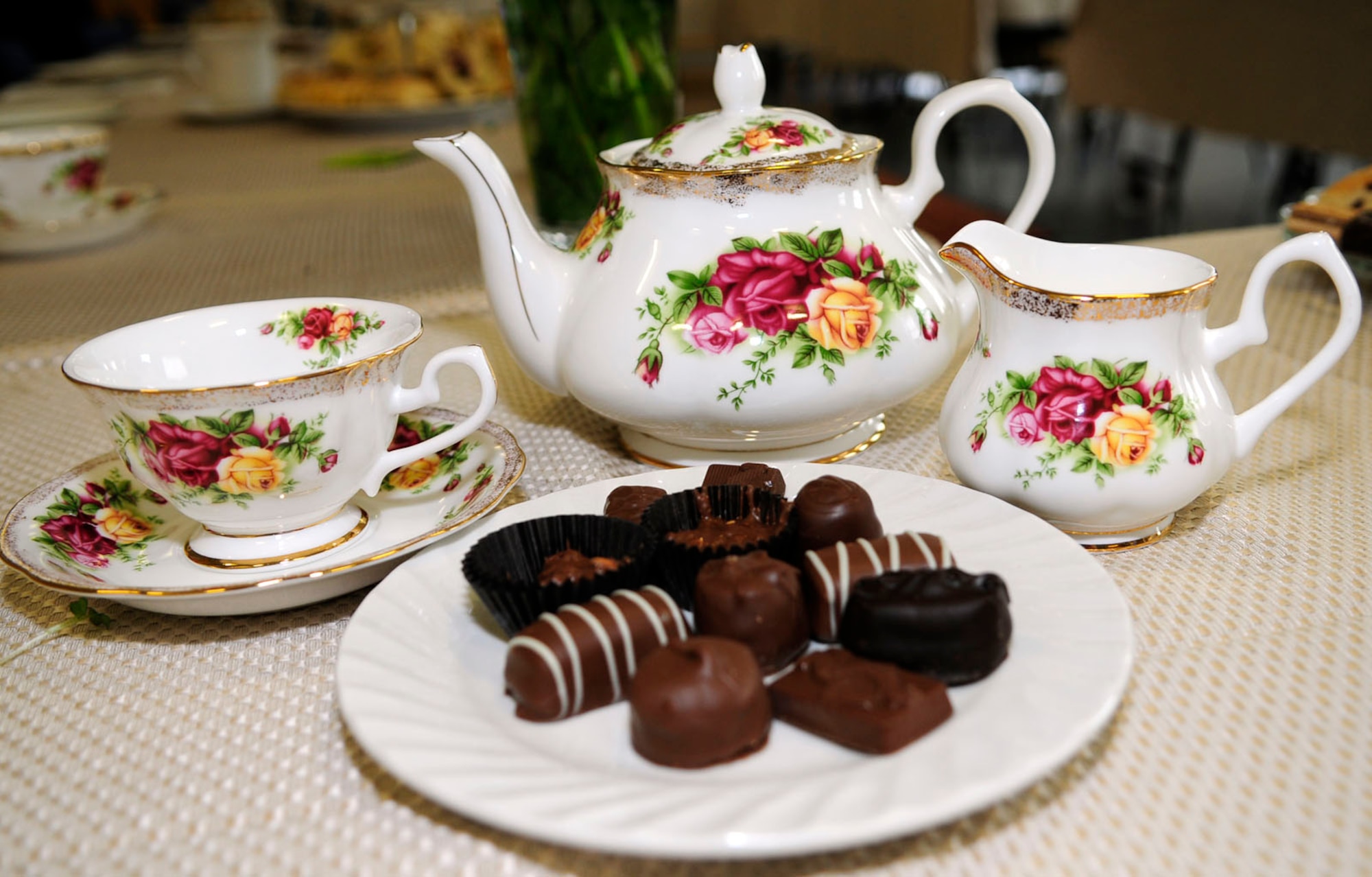 Tea and chocolates await military spouses who got together for High Tea May 20, 2014, at the chapel on RAF Mildenhall, England. The Airman and Family Readiness Center hosted the event to honor military spouses and the sacrifices they make for their families and the military. Thirty-five spouses met for scones, sandwiches, tea, chocolates and chat as they partook in one of several events throughout the day in their honor. (U.S. Air Force photo by Karen Abeyasekere/Released)
