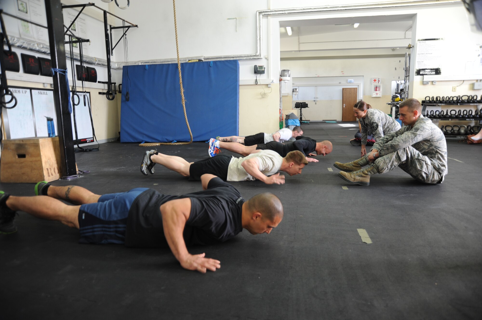 Participants compete in the pushup event during the Wing Staff Agencies Iron Airman competition May 23, 2014, at Spangdahlem Air Base, Germany. Points were earned for every repetition that competitors completed and per yard the ball traveled in the pass, punt, and kick events.  (U.S. Air Force photo by Airman 1st Class Dylan Nuckolls/Released) 