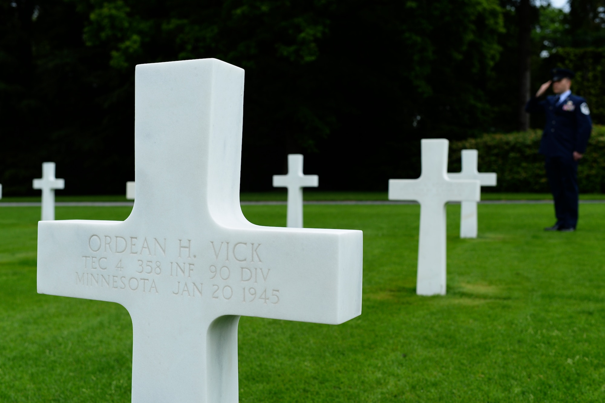 U.S. Air Force Master Sgt. Michael Murieen, 52nd Civil Engineer Squadron section chief of water fuel and systems maintenance, salutes a headstone at the Luxembourg American Military Cemetery May 21, 2014, at Luxembourg City, Luxembourg. More than 5,000 American service members are interred at the cemetery. (U.S. Air Force photo by Senior Airman Rusty Frank/Released)