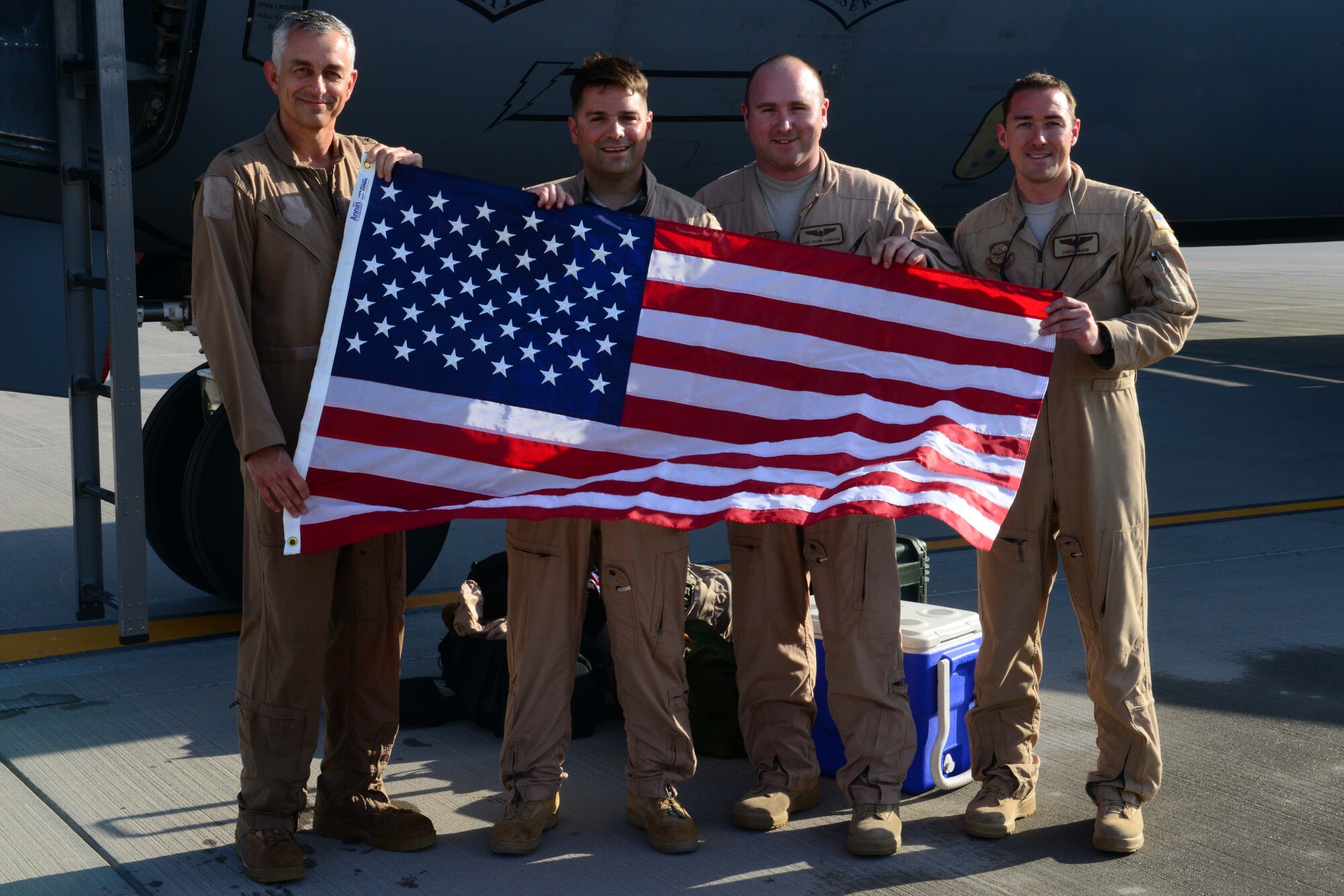 U.S. Air Force Brig. Gen. Roger H. Watkins, 379th Air Expeditionary Wing commander, poses for a photo with his aircrew after a fini flight at Al Udeid Air Base, Qatar, May 20, 2014. Watkins is a command pilot with more than 3,400 flight hours. He hails from Fort Worth, Texas. (U.S. Air Force photo Staff Sgt. Ciara Wymbs)