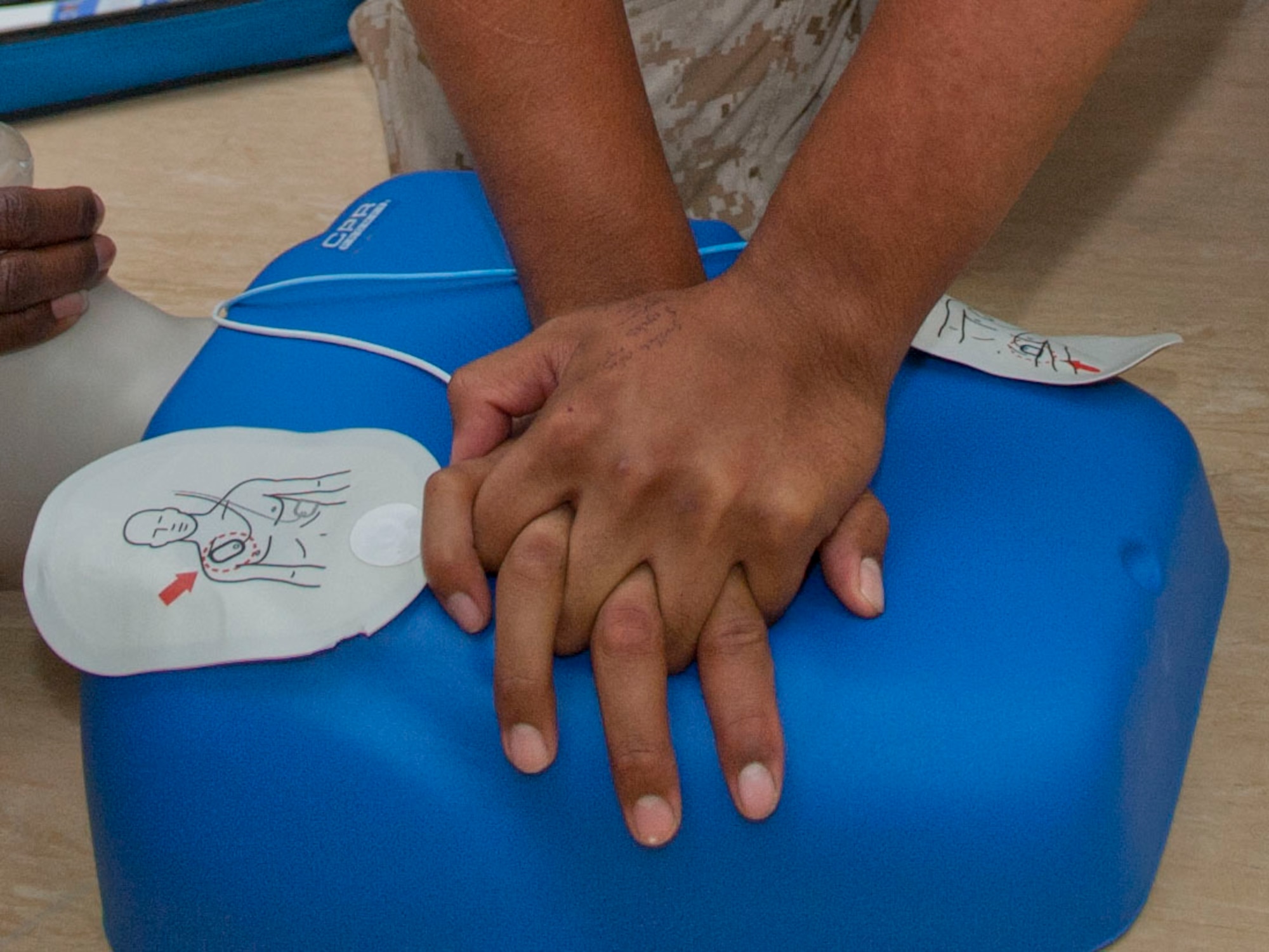 U.S Marine Corps Lance Corporal Thomas Kaseca, Marine Aircraft Group-14 Marine Tactical Electronic Warfare Squadron 3 munitions aviation ordnance technician, practices cardiopulmonary resuscitation procedures during a CPR class May 17, at Al Udeid Air Base, Qatar. CPR is a lifesaving technique used in many emergencies including heart attacks or near drownings, in which someone’s breathing and or heartbeat has stopped. Two separate classes were offered, during which 38 Marines, Airmen and soldiers were trained. Kaseca home station is Marine Corps Air Station Cherry Point, North Carolina, and his hometown is Anadarko, Oklahoma (U.S. Air Force photo/Senior Airman Colin Cates)
