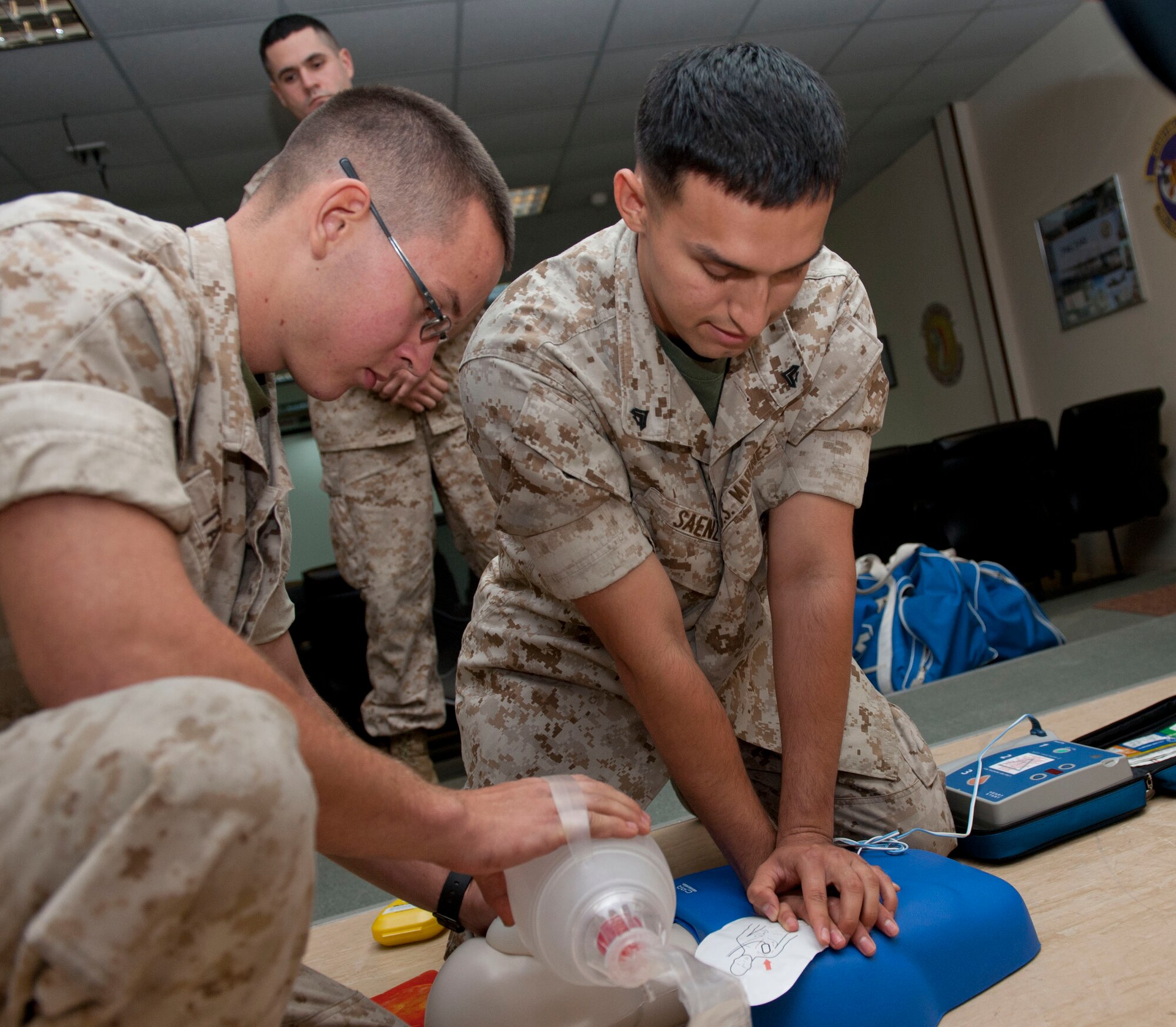 U.S Marine Corps Lance Corporal Adrian Saenz, Marine Aircraft Group-14 Marine Tactical Electronic Warfare Squadron 3 communications navigator, and U.S Marine Corps Corporal Patrick Taylor, Marine Aircraft Group-14 Marine Tactical Electronic Warfare Squadron 3 seat shop technician, practice cardiopulmonary resuscitation procedures during a class May 17, at Al Udeid Air Base, Qatar. CPR is a lifesaving technique used in many emergencies including heart attacks or near drownings, in which someone’s breathing and or heartbeat has stopped.  Two separate classes were offered, during which 38 Marines, Airmen and soldiers were trained. Taylor and Saenz’s home stations are Marine Corps Air Station Cherry Point, North Carolina. Taylor’s hometown is Laconia New Hampshire. Saenz hometown is Madera, California.  (U.S. Air Force photo/Senior Airman Colin Cates)