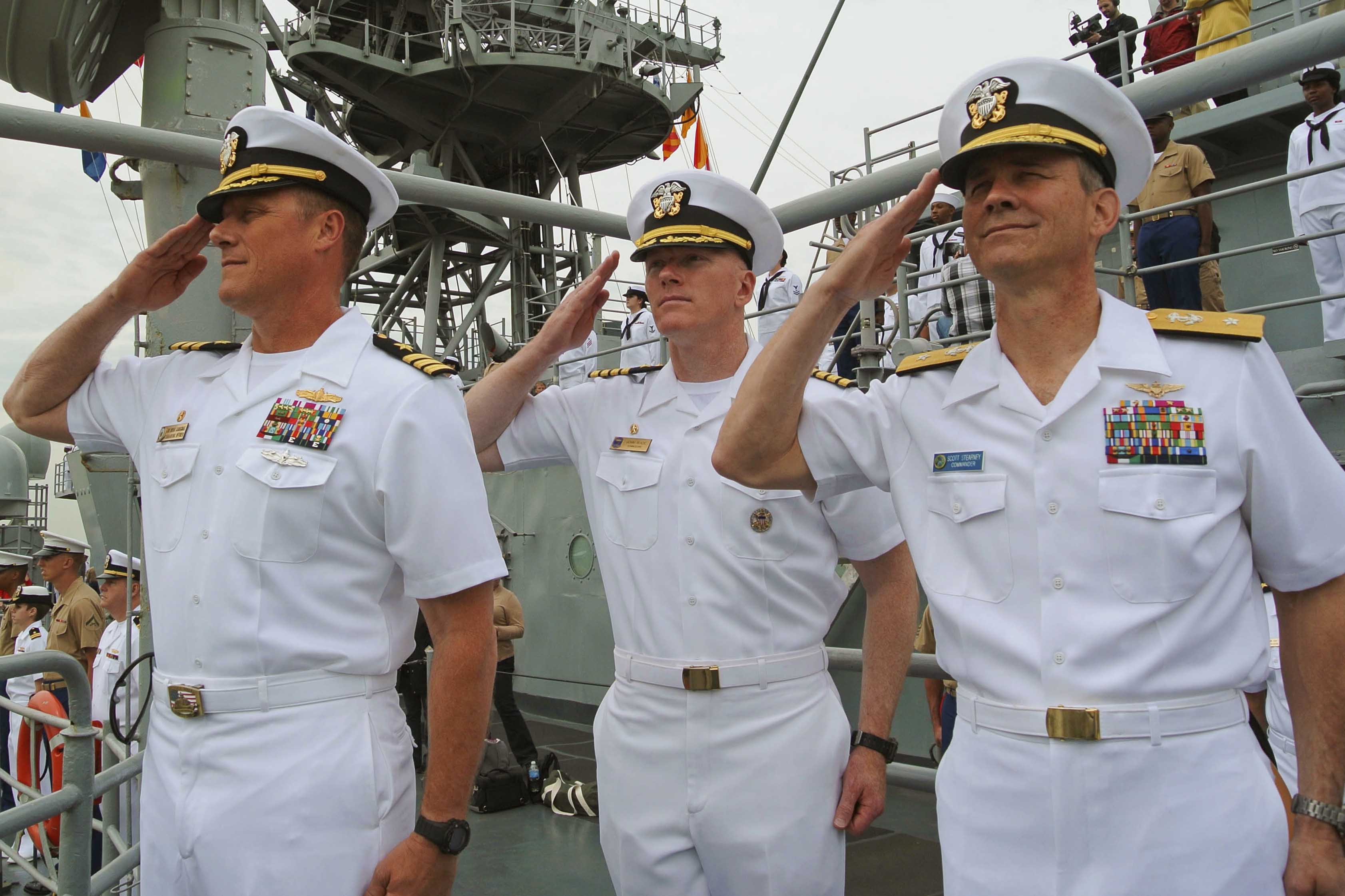 U.S. Navy Cmdr. Bryan Carmichael, left, commanding officer of the ...