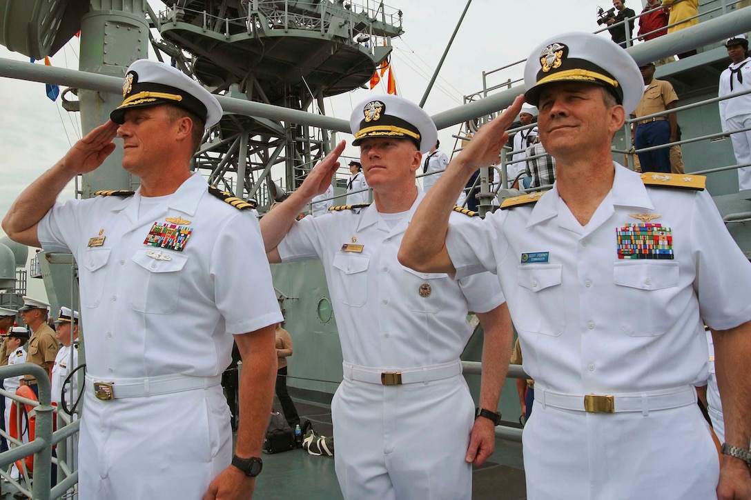 U.S. Navy Cmdr. Bryan Carmichael, left, commanding officer of the ...