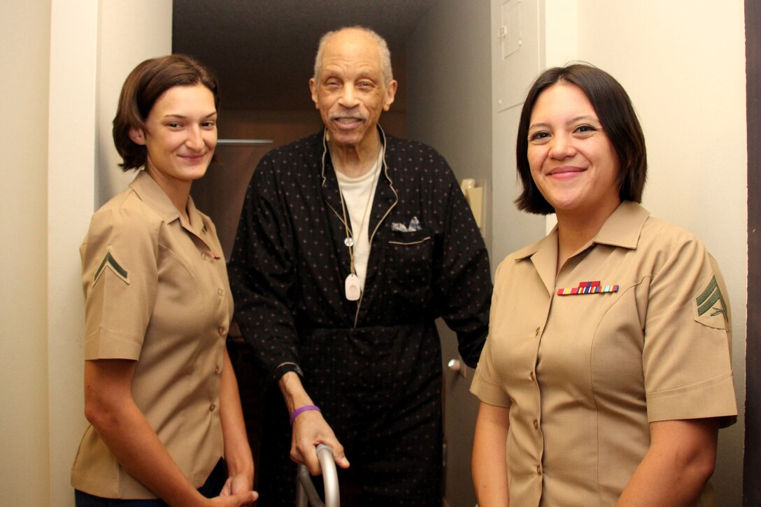 Marine Pfc. Theresa Cole, left, and Marine Corps Cpl. Shira Hennecke pose for a photo with an elderly New Yorker after delivering a  lunch-time meal during Fleet Week . Cole and Hennecke are among military personnel of the sea services who volunteered to deliver meals to people who are unable to leave their homes. The Marines are currently serving aboard the USS Oak Hill, an amphibious dock landing ship. 