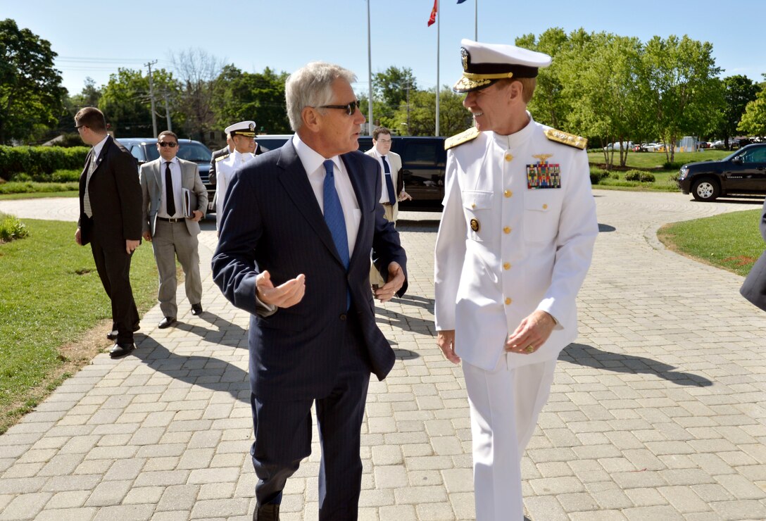 Defense Secretary Chuck Hagel and Navy Vice Adm. Mike Miller, the 61st superintendent of the U.S. Naval Academy, walk together as Hagel arrives to deliver the commencement address at the U.S. Naval Academy in Annapolis, Md., May 23, 2014. 