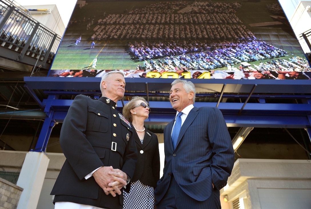 Defense Secretary Chuck Hagel chats with Marine Corps Commandant Gen. James F. Amos and his wife, Bonnie, before the start of the commencement  ceremony at the U.S. Naval Academy in Annapolis, Md., May 23, 2014. 