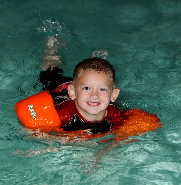 Dakota Lehman, son of Mary Lehman, 2nd Medical Squadron, plays in the water during the Pool Bash at the North Gate Pool on Barksdale Air Force Base, La., May 23, 2014. Lehman was one of the last children in the pool, only getting out because the Pool Bash, celebrating the opening of the pool for summer, had finally ended. (U.S. Air Force photo/Senior Airman Joseph A. Pagán Jr.)