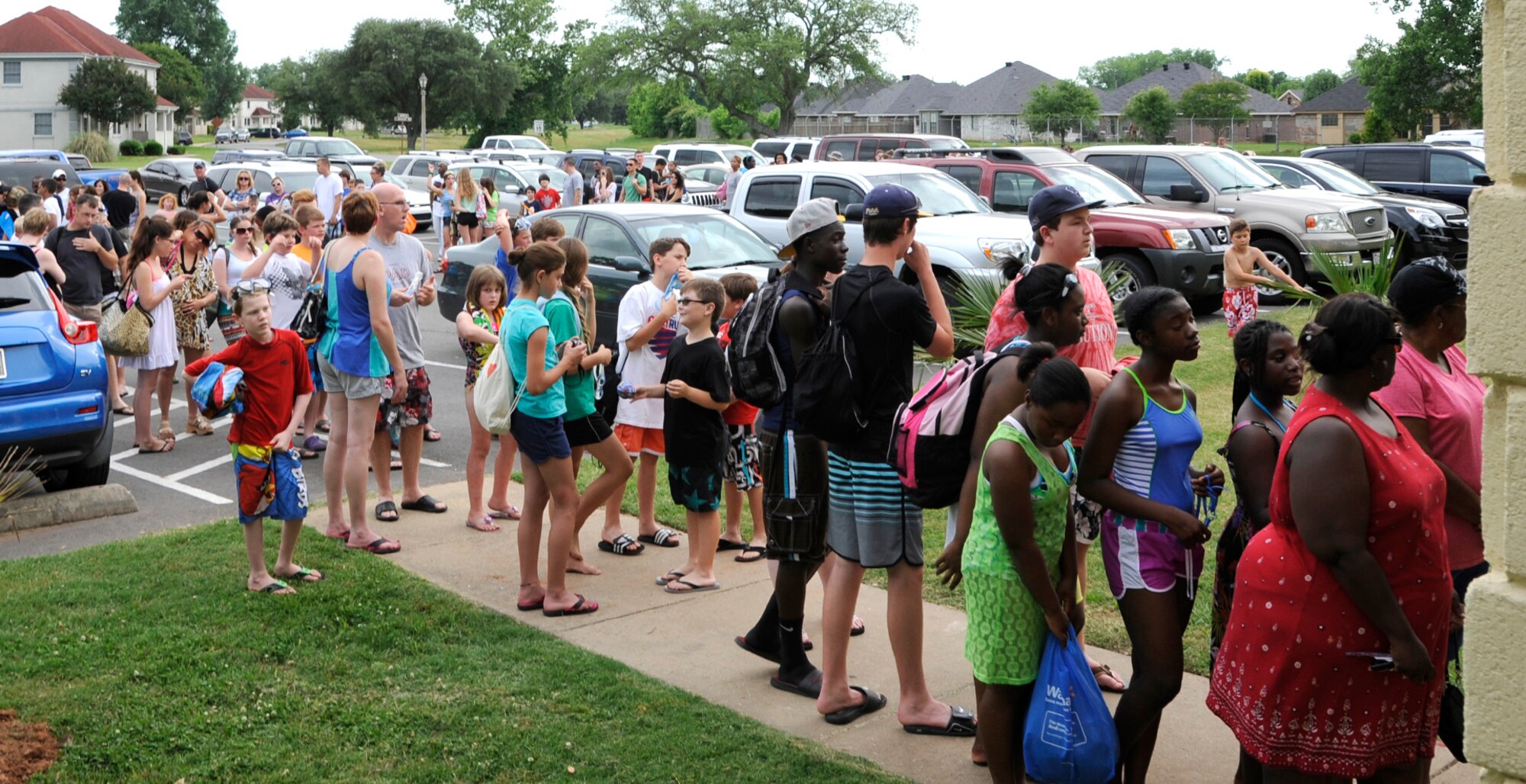 Pool Bash guests wait outside the North Gate Pool on Barksdale Air Force Base, La., May 23, 2014. For the first day of pool season, guests enjoyed free admission and food and drinks that were provided during the Pool Bash. (U.S. Air Force photo/Senior Airman Joseph A. Pagán Jr.)