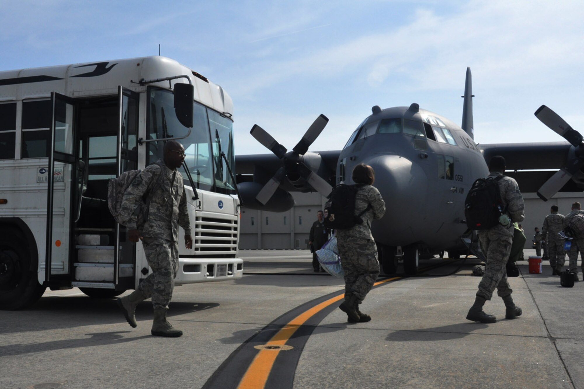 Service Members from the 94th Airlift Wing walk off of a bus and load onto a C-130 aircraft, May 24, 2014, Dobbins Air Reserve Base, Ga. The C-130 is headed to participate in an international aerial training exercise in Canada.  (U.S. Air Force photo/Senior Airman Miles Wilson)