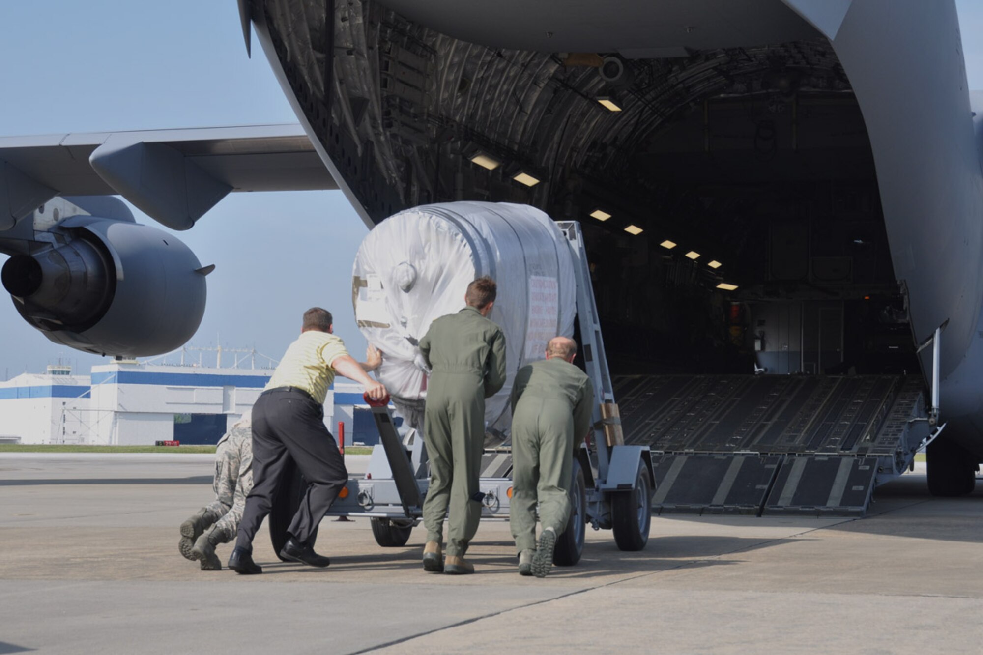 Members of the 94th Logistics Readiness Squadron Traffic Management Office and 701st Airlift Squadron load a C-130 aircraft engine onto a C-17 aircraft heading to the Maple Flag exercise, May 22, 2014, Dobbins Air Reserve Base, Ga. In the event that an engine fails during the exercise, the engine will be available for maintenance. (U.S. Air Force photo/Senior Airman Miles Wilson)
