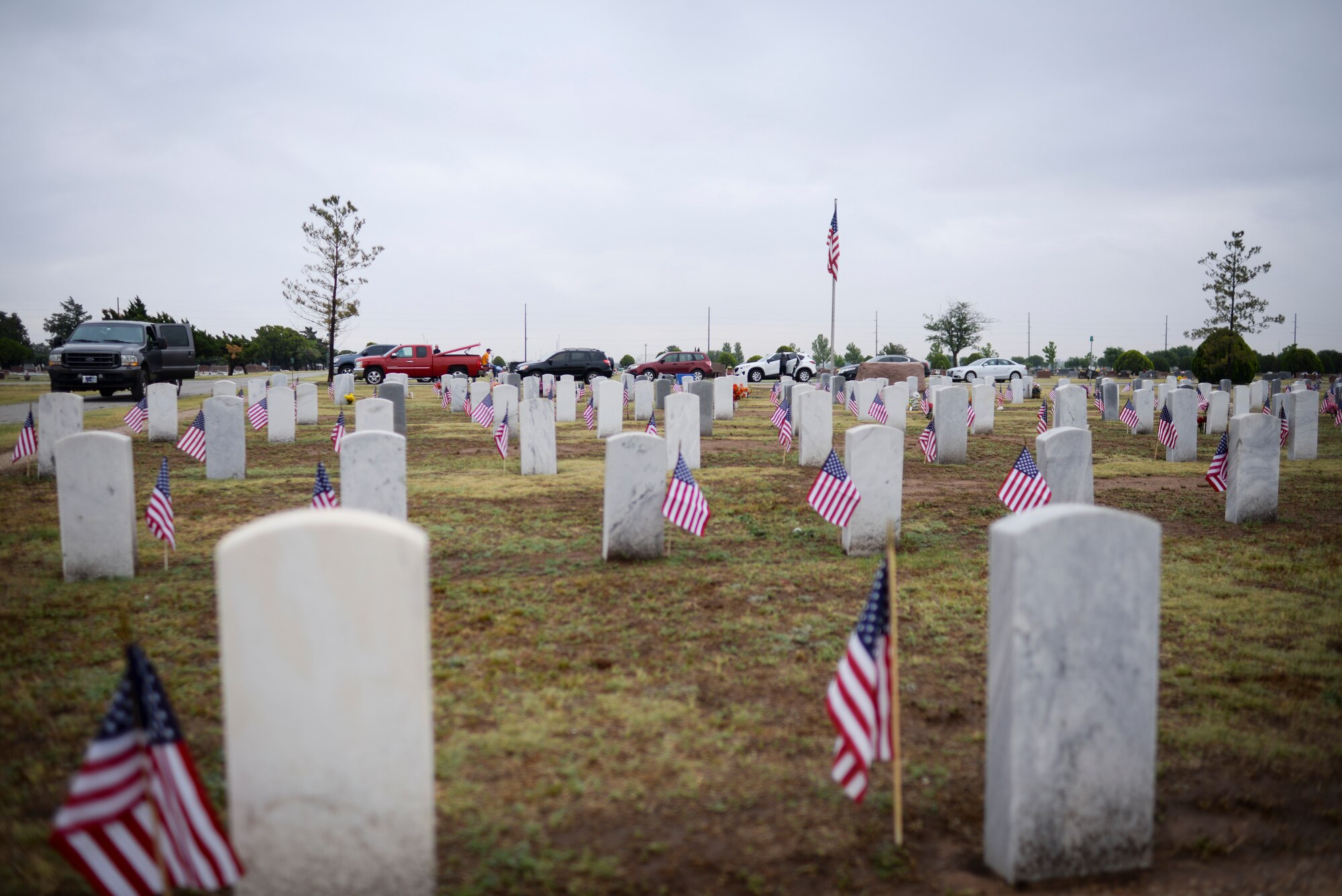ALTUS, Okla. – U.S. flags wave next to veterans' tombstones in the Veterans Garden at the Altus City Cemetery, May 24, 2014. Airmen from Altus Air Force Base placed flags next to the tombstones of deceased U.S. service members in remembrance of Memorial Day, which is held on the last Monday in May every year. (U.S. Air Force photo by Staff Sgt. Nathanael Callon/Released) 