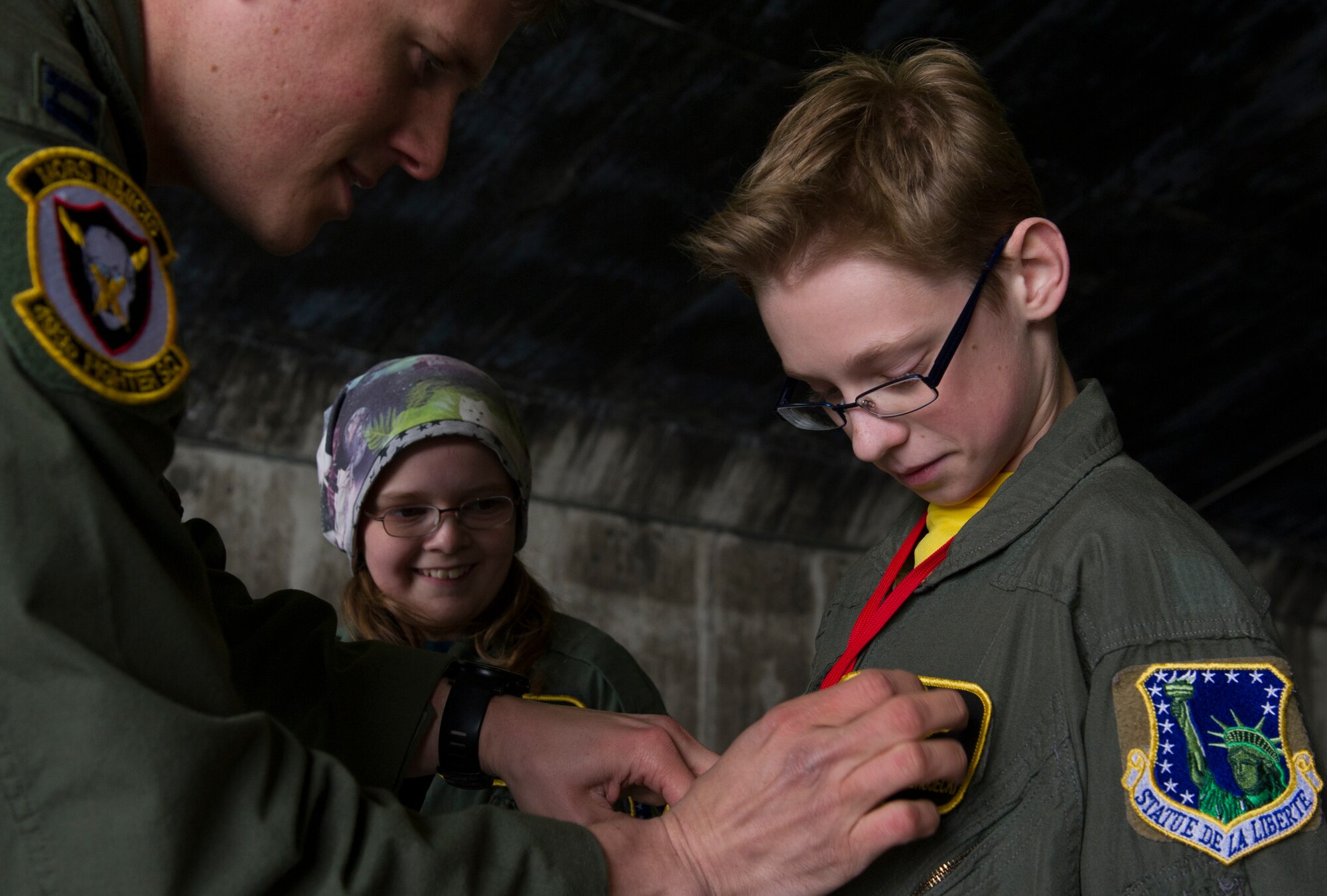 KEFLAVIK, Iceland -- Capt. Matt Tanis, 48th Air Expeditionary Group F-15C Eagle pilot, presents flight wings to Mikolaj Chojecki, 14, at the end of the pilot-for-a-day program at Keflavik International Airport May 23, 2014. Airmen deployed with the 48th AEG took time out of their day to brighten the lives of the two children who have been struggling with serious long-term illnesses. (U.S. Air Force photo/Tech. Sgt. Benjamin Wilson)(Released)