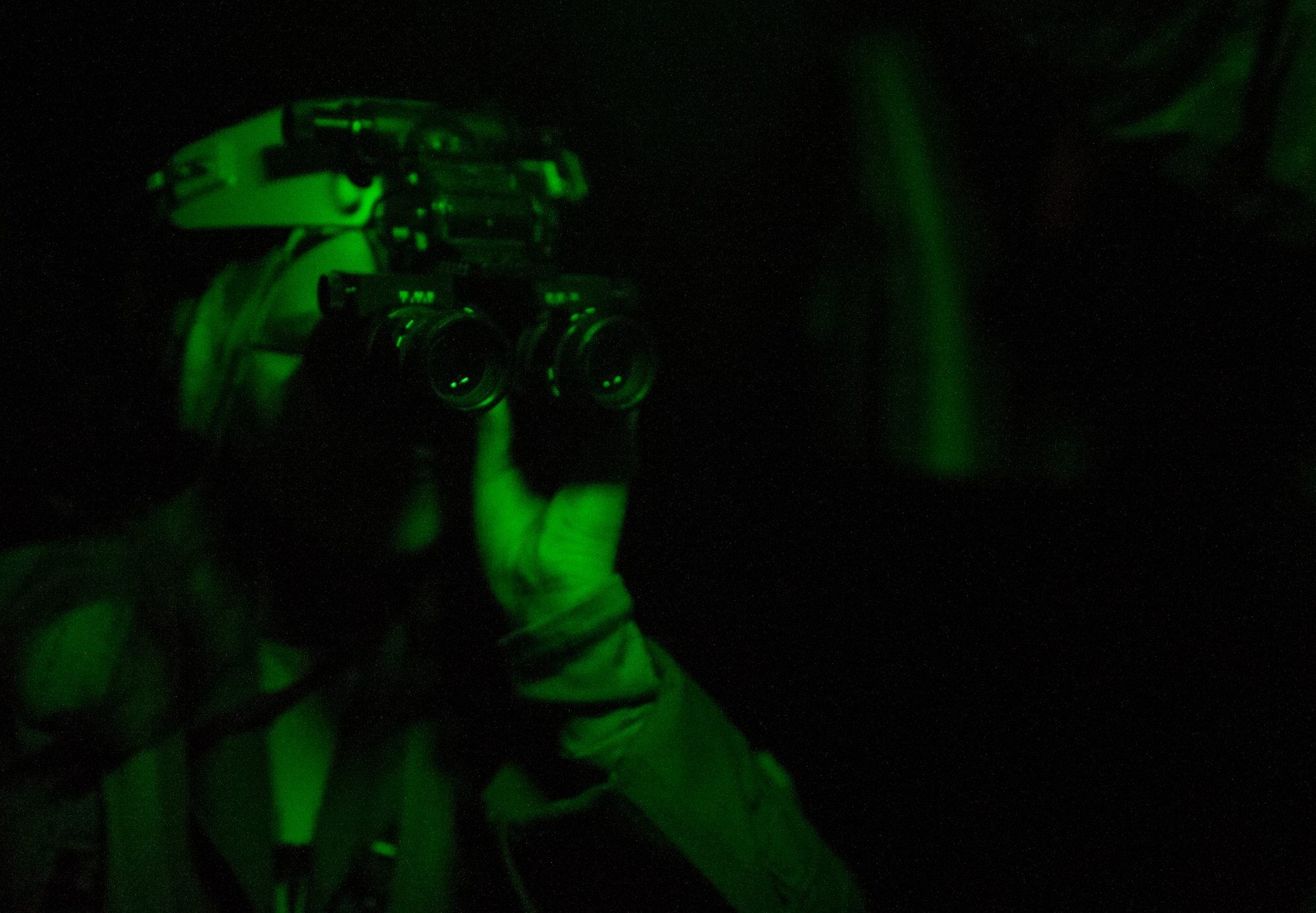 KEFLAVIK, Iceland -- Kolbrun Erlendsdottir, 11, tests out a pair of night vision goggles during the pilot-for-a-day program at Keflavik International Airport May 23, 2014. Airmen deployed with the 48th AEG took time out of their day to brighten the lives of the two children who have been struggling with serious long-term illnesses. (U.S. Air Force photo/Tech. Sgt. Benjamin Wilson)(Released)