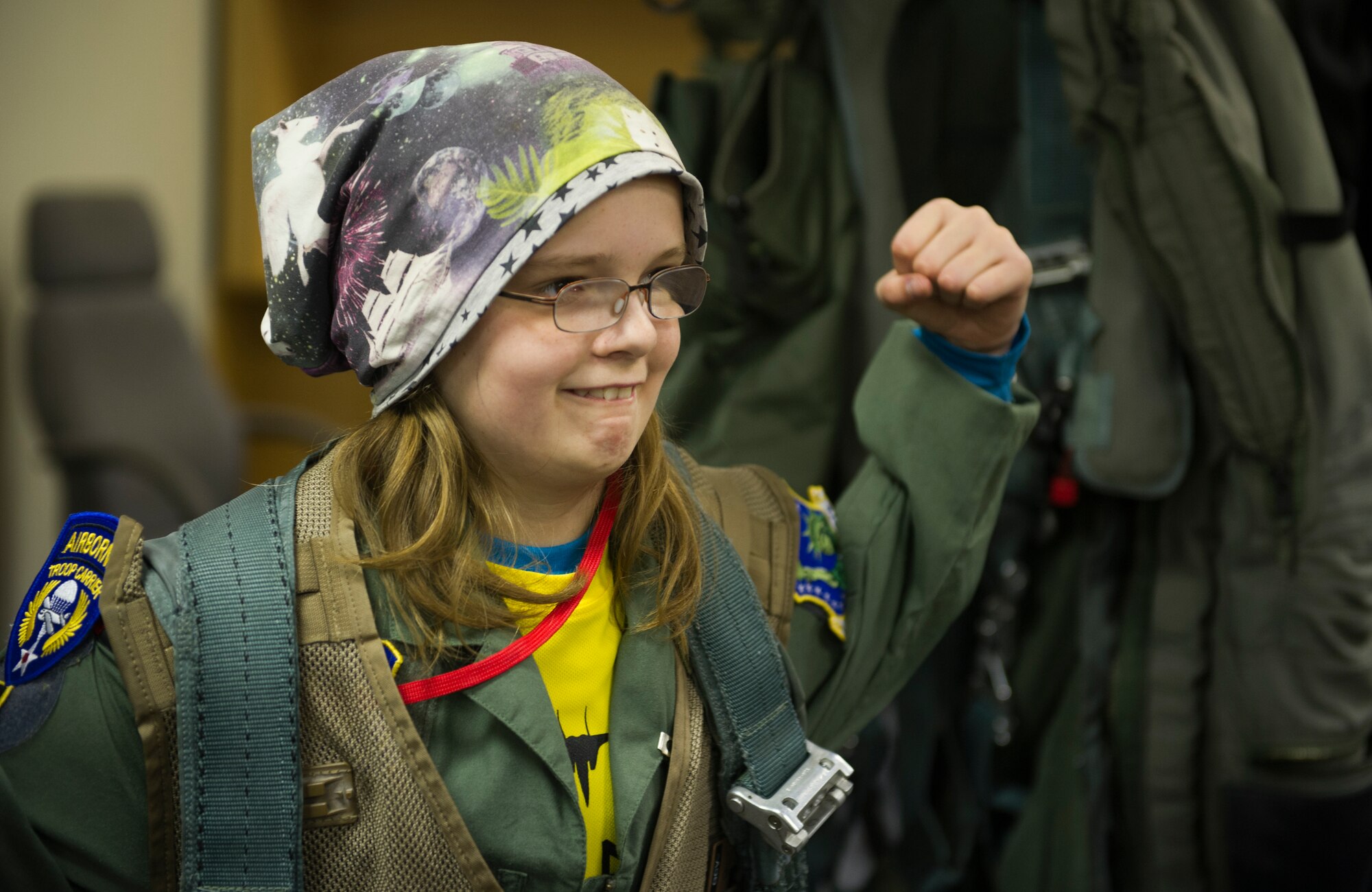 KEFLAVIK, Iceland -- Kolbrun Erlendsdottir, 11, shows her mother how strong she is during the pilot-for-a-day program at Keflavik International Airport May 23, 2014. Airmen deployed with the 48th AEG took time out of their day to brighten the lives of two children who have been struggling with serious long-term illnesses. (U.S. Air Force photo/Tech. Sgt. Benjamin Wilson)(Released)