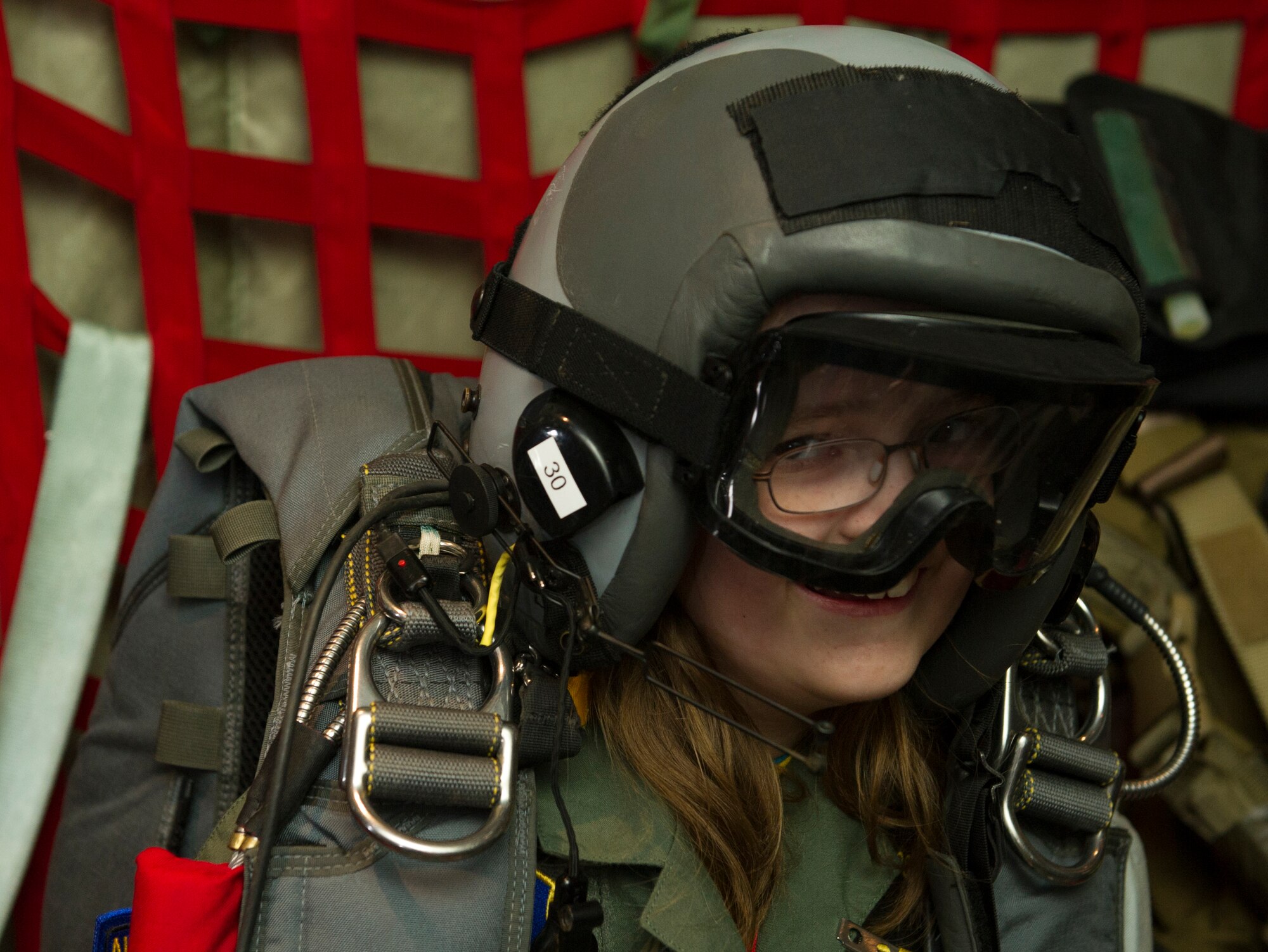 KEFLAVIK, Iceland -- Kolbrun Erlendsdottir, 11, wears pararescue equipment in the back of a C-130J Super Hercules during the pilot-for-a-day program at Keflavik International Air Port May 23, 2014. Airmen deployed with the 48th Air Expeditionary Group took time out of their day to brighten the lives of two children, Kolbrun and Mikolaj Chojecki, who have been struggling with serious long-term illnesses. (U.S. Air Force photo/Tech. Sgt. Benjamin Wilson)(Released)