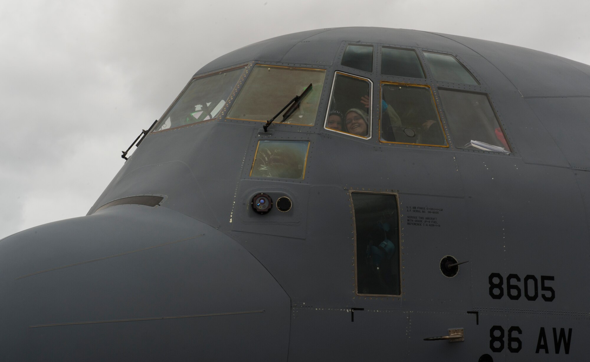 KEFLAVIK, Iceland -- Kolbrun Erlendsdottir, 11, and her brother, Stefan Erlendsson, 8, wave from the flight deck of a C-130J Super Hercules deployed from Ramstein Air Base during the pilot-for-a-day program at Keflavik International Air Port May 23, 2014. Airmen deployed with the 48th Air Expeditionary Group took time out of their day to brighten the lives of two children, Kolbrun and Mikolaj Chojecki, who have been struggling with serious long-term illnesses. (U.S. Air Force photo/Tech. Sgt. Benjamin Wilson)(Released)