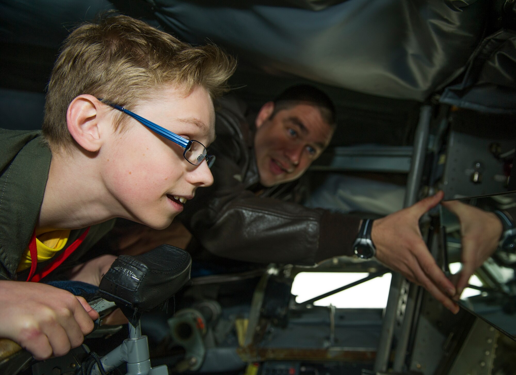 KEFLAVIK, Iceland -- Tech. Sgt. Joseph Blakley, 48th Air Expeditionary Group KC-135 Stratotanker boom operator, explains the controls of the aircraft’s boom pod to Mikolaj Chojecki, 14, during the pilot-for-a-day program at Keflavik International Air Port May 23, 2014. Airmen deployed with the 48th AEG took time out of their day to brighten the lives of two children who have been struggling with serious long-term illnesses. (U.S. Air Force photo/Tech. Sgt. Benjamin Wilson)(Released)