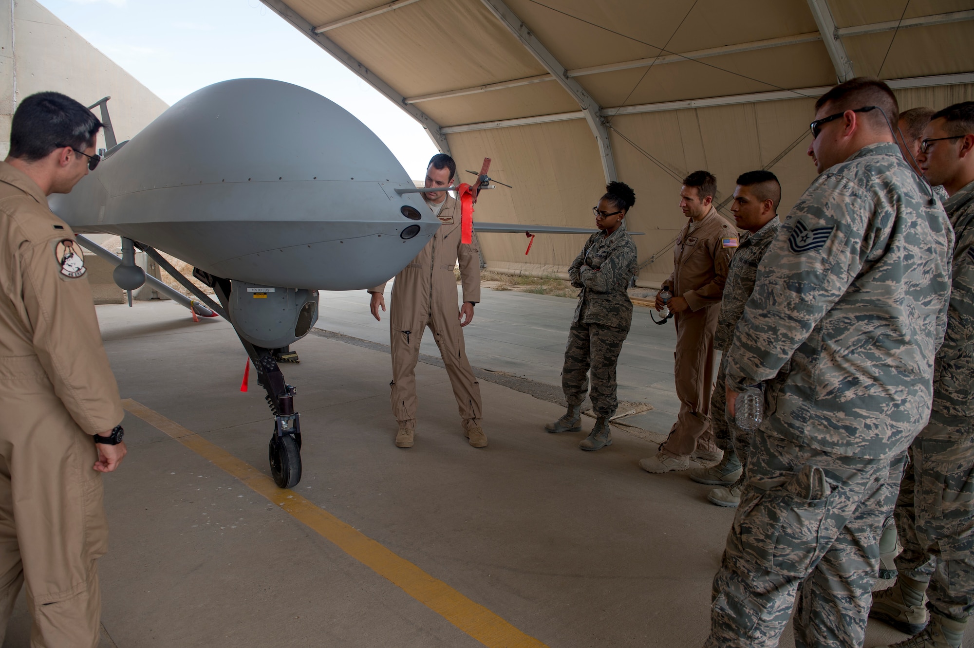Members of the 386th Expeditionary Civil Engineering Squadron took part in the Operations Group’s Aircrew for a Day program, May 16, 2014. During the event, non-flying military members were given tours of aircraft facilities, three separate planes, and were also briefed by operations personnel on the activities that aircrew members go through on a daily basis. The tours included the 46th Expeditionary Reconnaissance Squadron, C-130 operations from the 386th Expeditionary Operations Group and Apache helicopters from the Army’s flying unit here. (U.S. Air Force photo by Staff Sgt. Jeremy Bowcock)