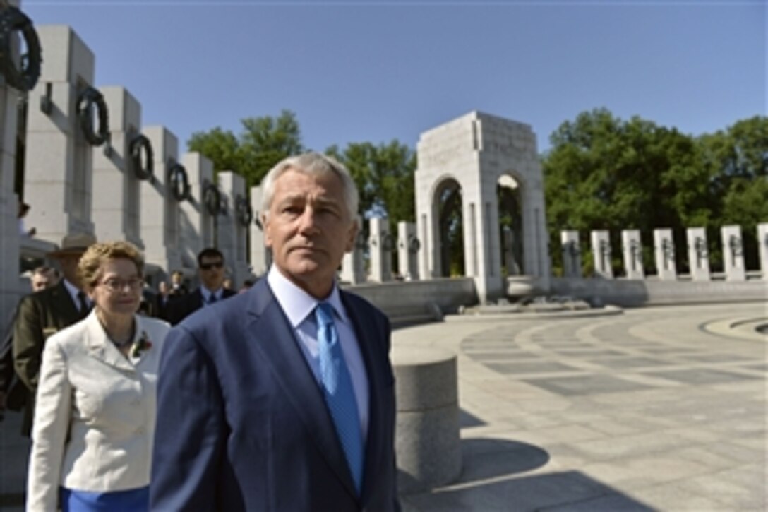 Defense Secretary Chuck Hagel glances toward the audience as he prepares to take his seat before a ceremony marking the 10th anniversary of the National World War II Memorial in Washington, D.C., May 24, 2014. Hagel delivered the keynote address. 