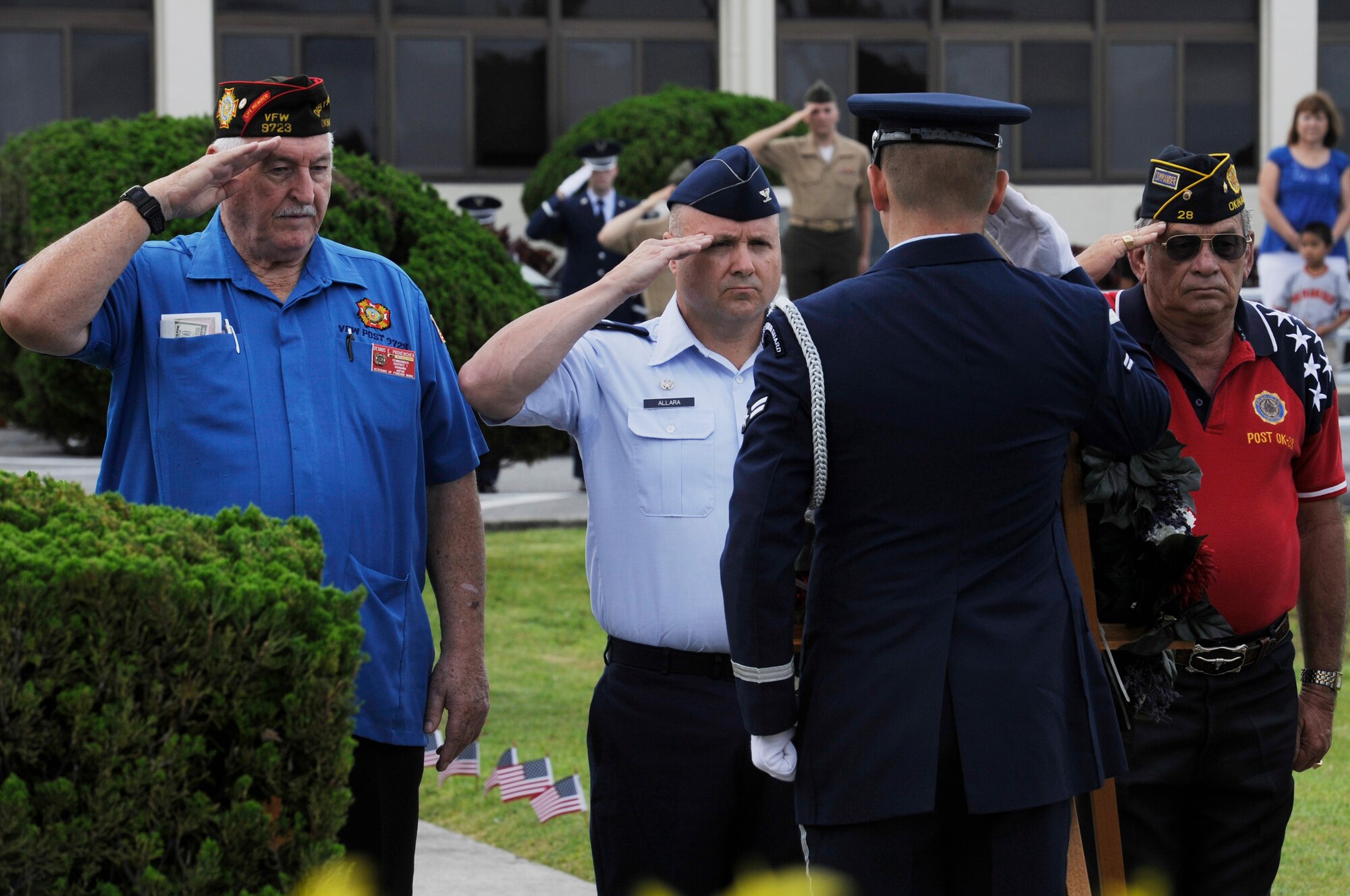 Dennis Provencher, left, Okinawa Veterans of Foreign Wars post 9723 commander, U.S. Air Force Col. Frank Allara, 18th Medical Group commander, and Charles Cathey, Okinawa American Legion post 28 commander, salute a wreath during a Memorial Day ceremony on Kadena Air Base, Japan, May 26, 2014. Formerly known as Decoration Day, Memorial Day is now observed as a day to remember those who have made the ultimate sacrifice so that the nation may live free today. (U.S. Air Force photo by Senior Airman Marcus Morris)