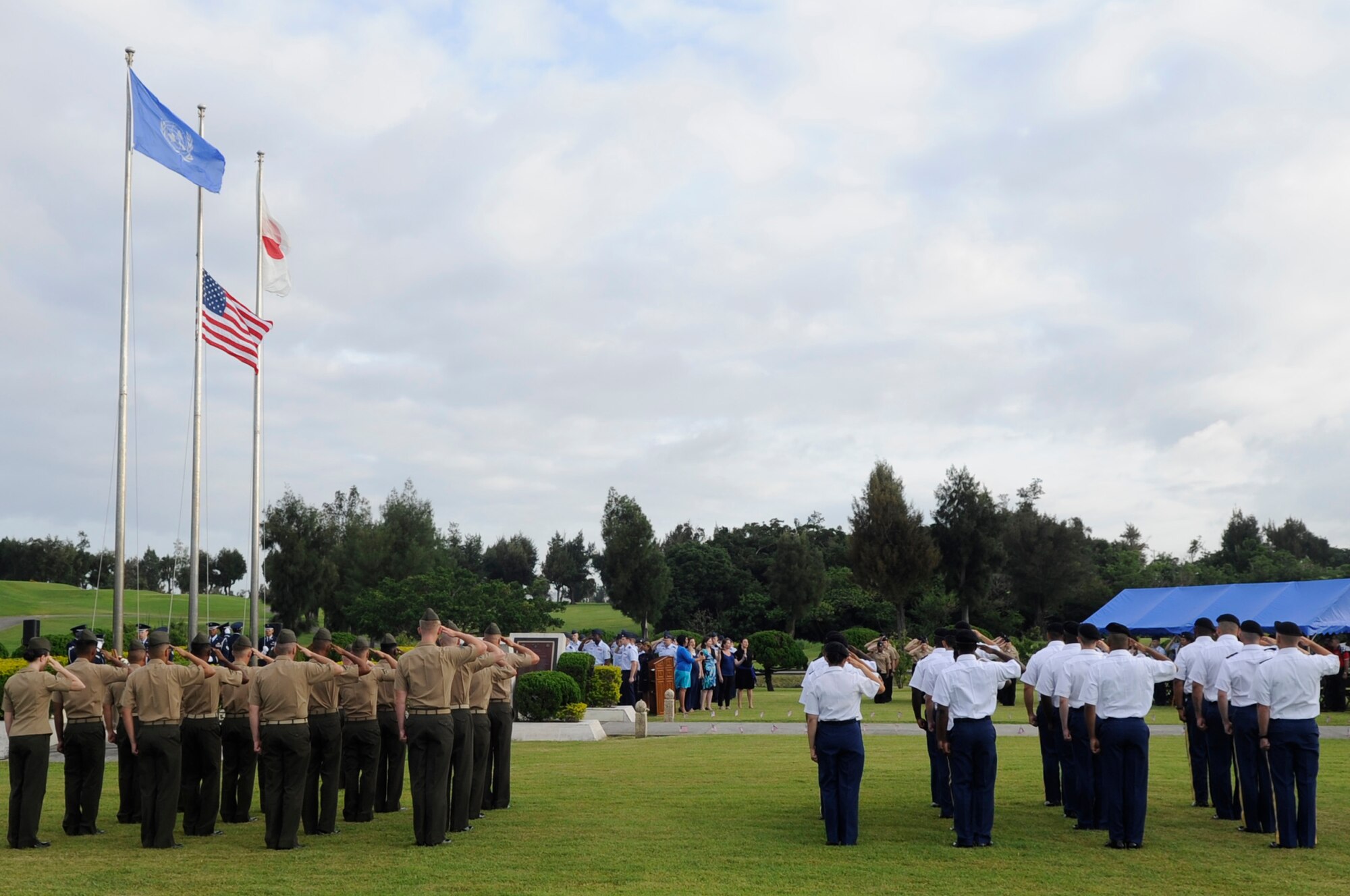 U.S. Air Force, Army, Marines and Navy render a salute to the flag during a Memorial Day ceremony on Kadena Air Base, Japan, May 26, 2014. More than a 100 service members, families and veterans attended the ceremony to remember those who lost their lives defending the nation. (U.S. Air Force photo by Senior Airman Marcus Morris)